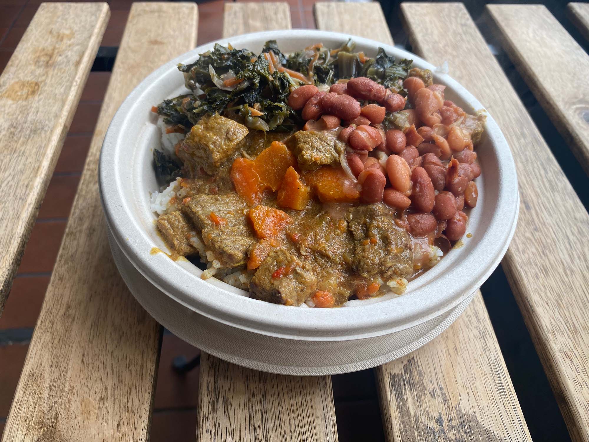 Beef curry bowl loaded with beans and greens.