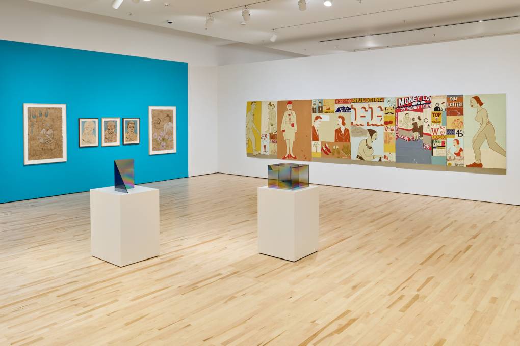 Gallery with watercolors on paper on a blue wall, two glass sculptures on pedestals and a wide painting