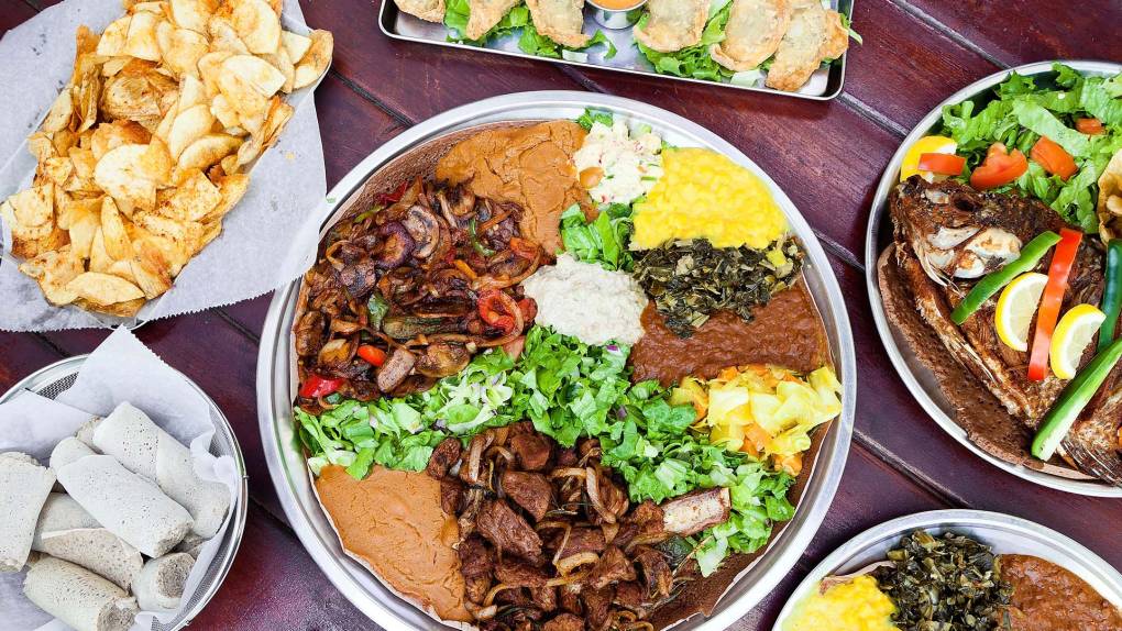 A sumptuous spread of Ethiopian dishes, including a large round platter lined with injera.