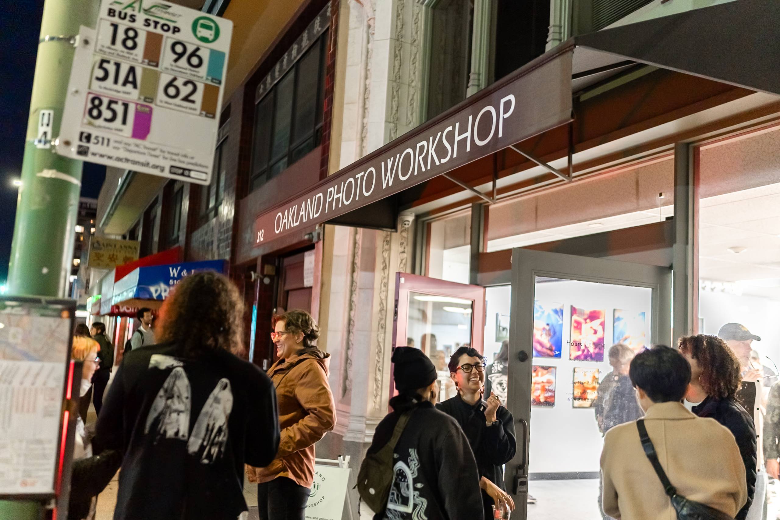 People gather outside of an event at the Oakland Photo Workshop headquarters in Oakland's Chinatown.