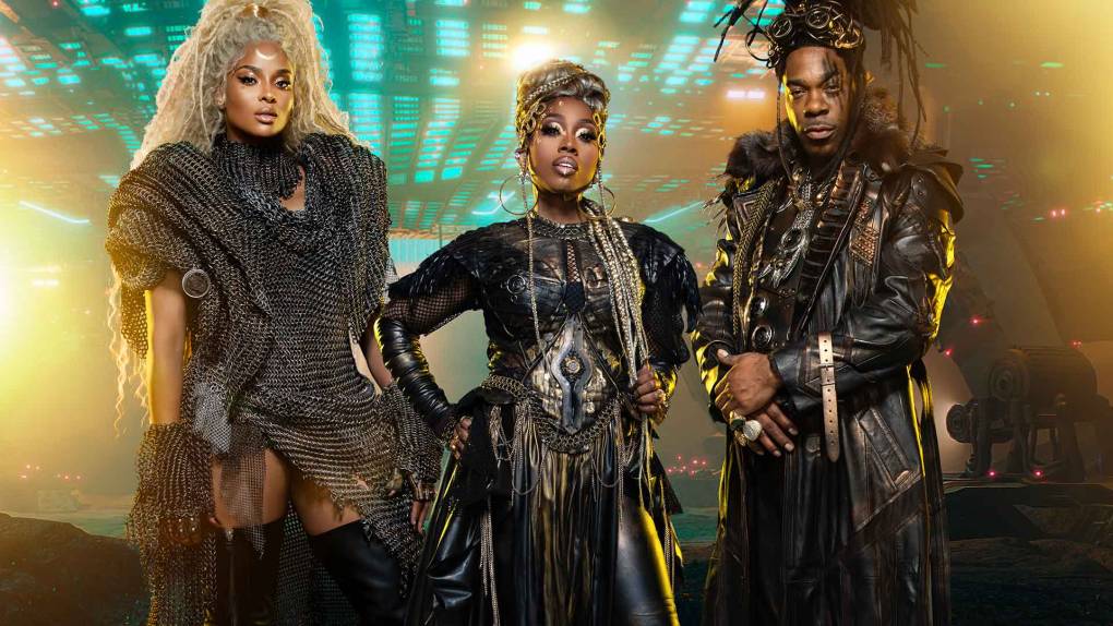 Three ornately dressed Black artists stand in a futuristic landscape