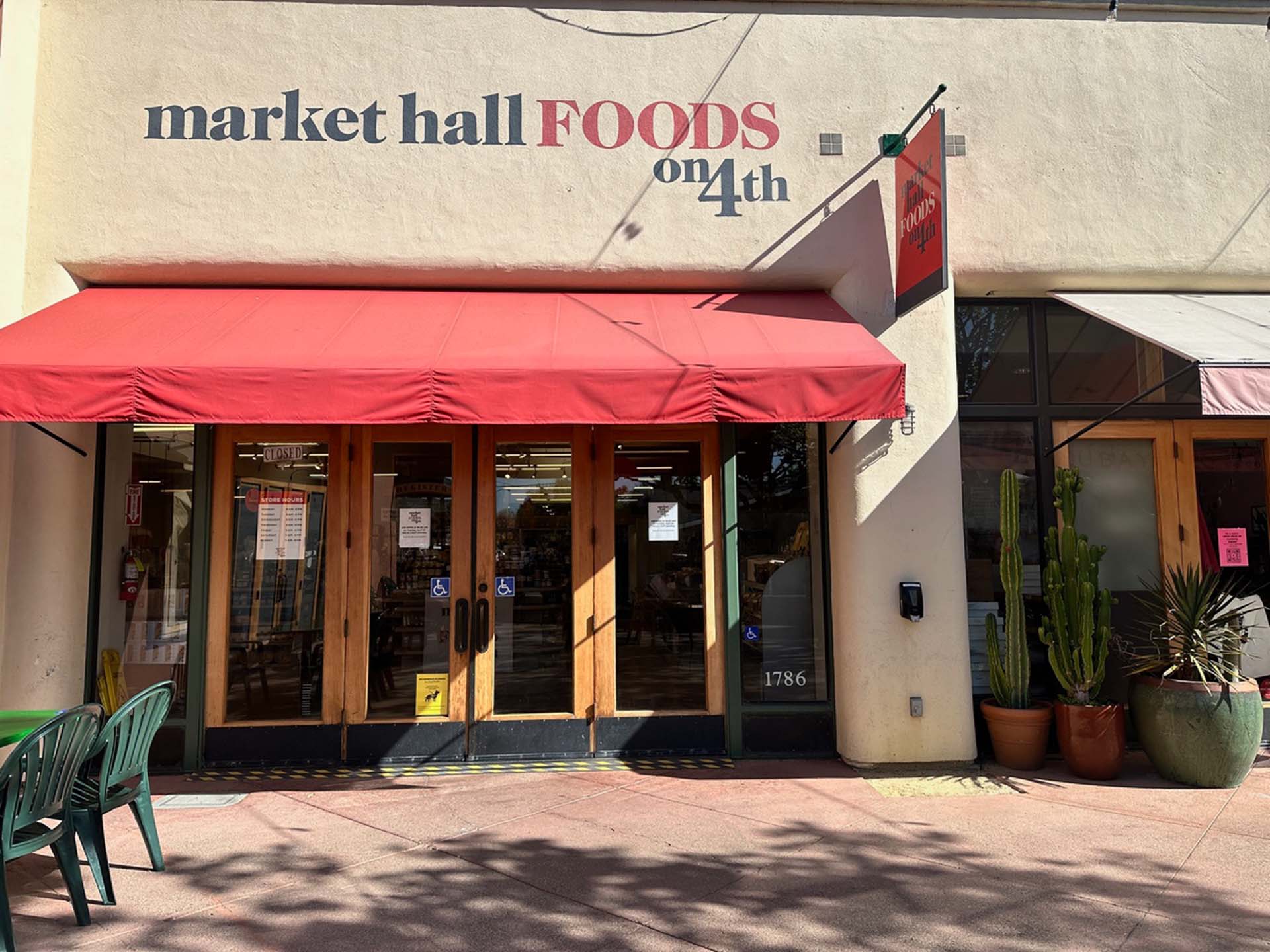 Exterior facade of a specialty grocery store. The sign reads, "Market Hall Foods on 4th."