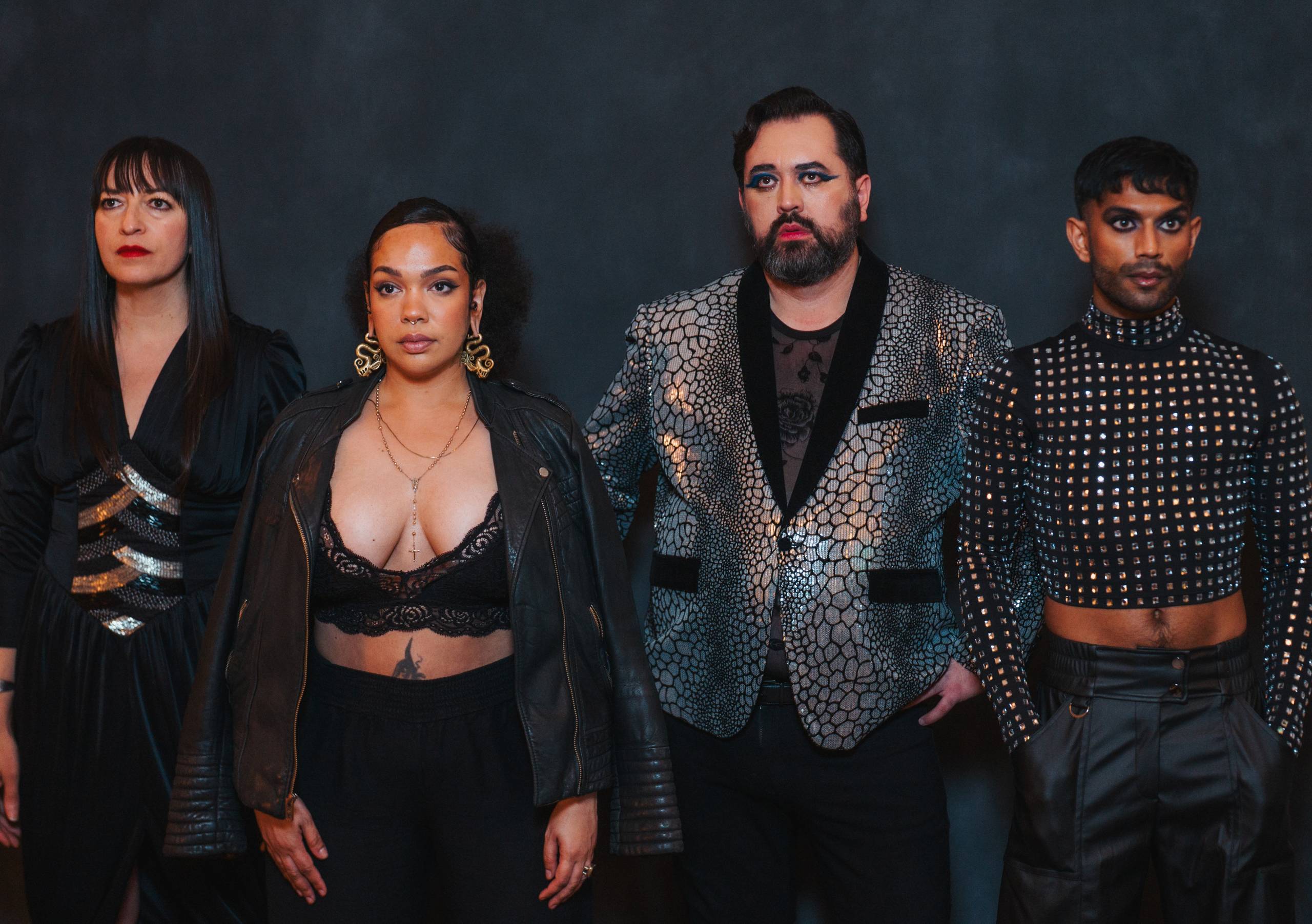 four stage performers pose for the camera