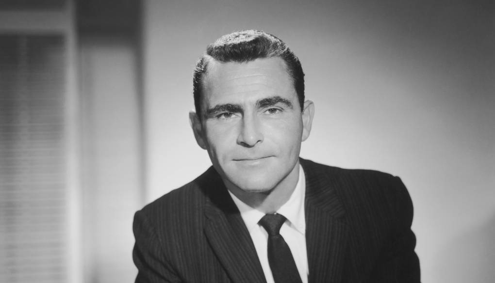 A black and white image of a white man in a 1950s-era suit.
