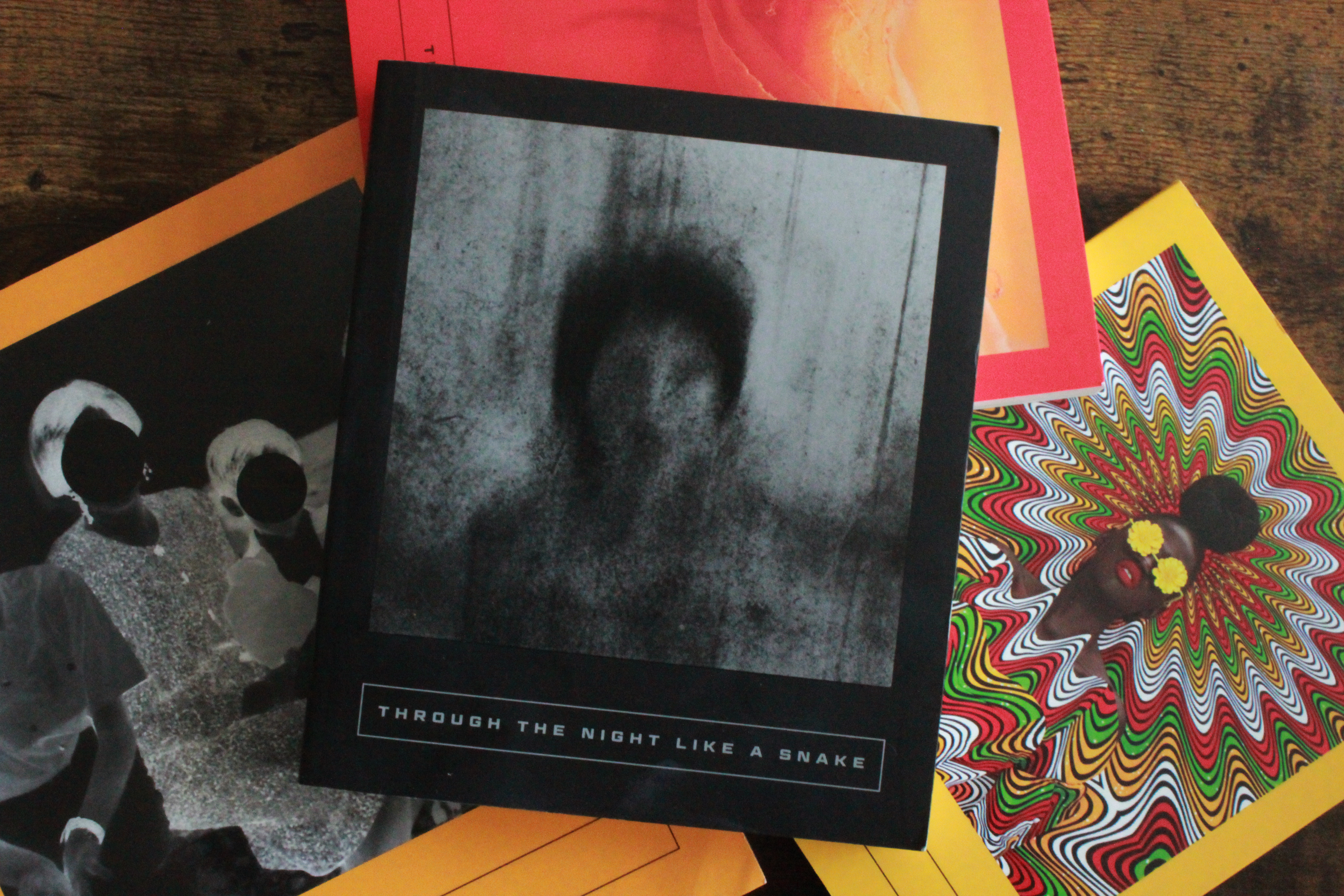 a collection of Latin American books are loosely scattered on a table