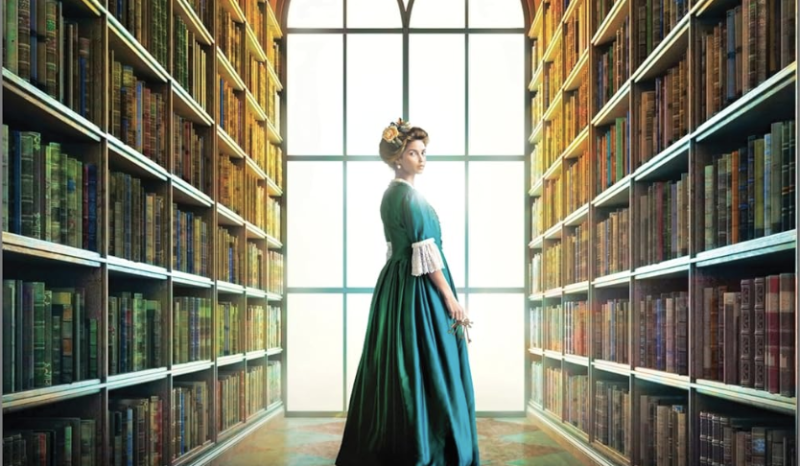 A book cover illustration shows a woman in late 19th century dress standing between tall stacks of books before a huge window.