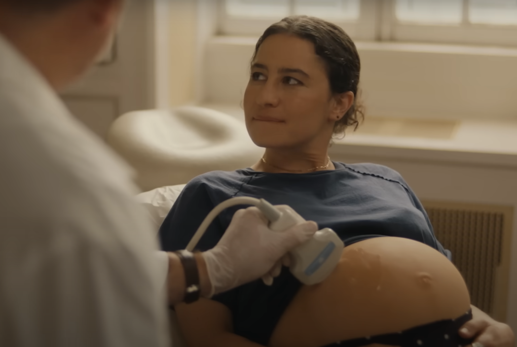 A pregnant woman has an ultrasound at a doctor's office.