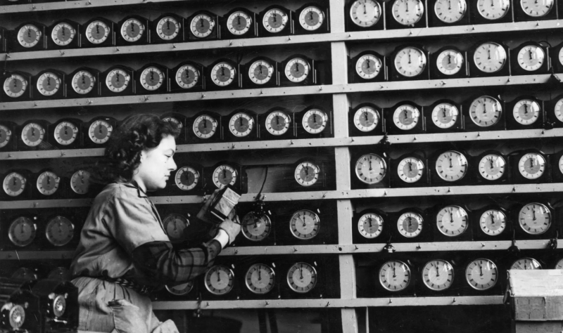 A woman checks alarm clocks in a London clock factory in 1946.