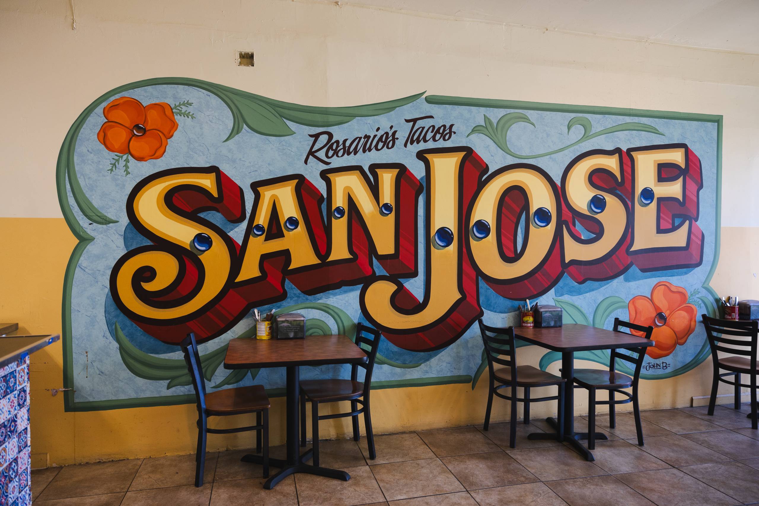 a mural that reads "Rosario's Tacos San Jose" inside a taqueria