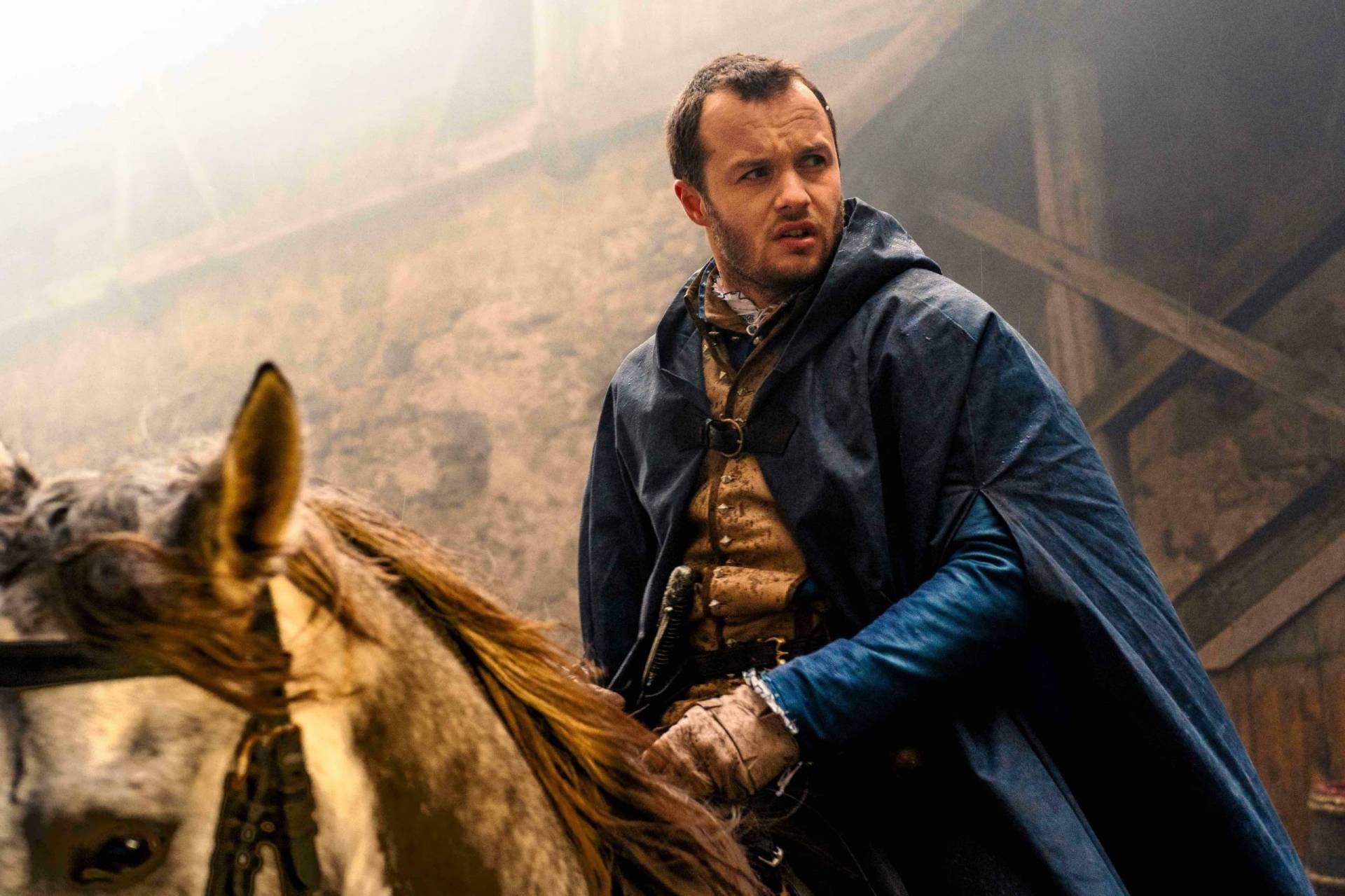 A concerned looking man on horseback.
