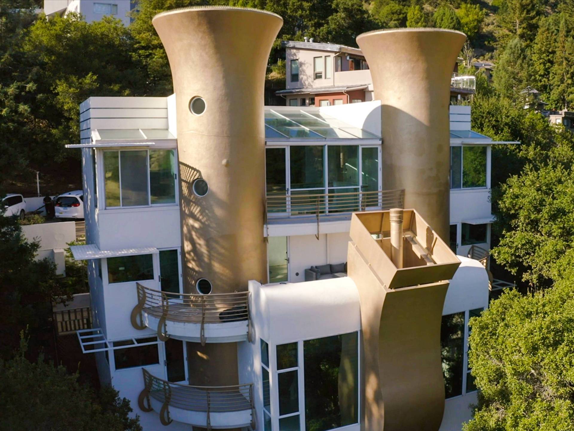 A large white house with huge gold chimneys dominating the front.