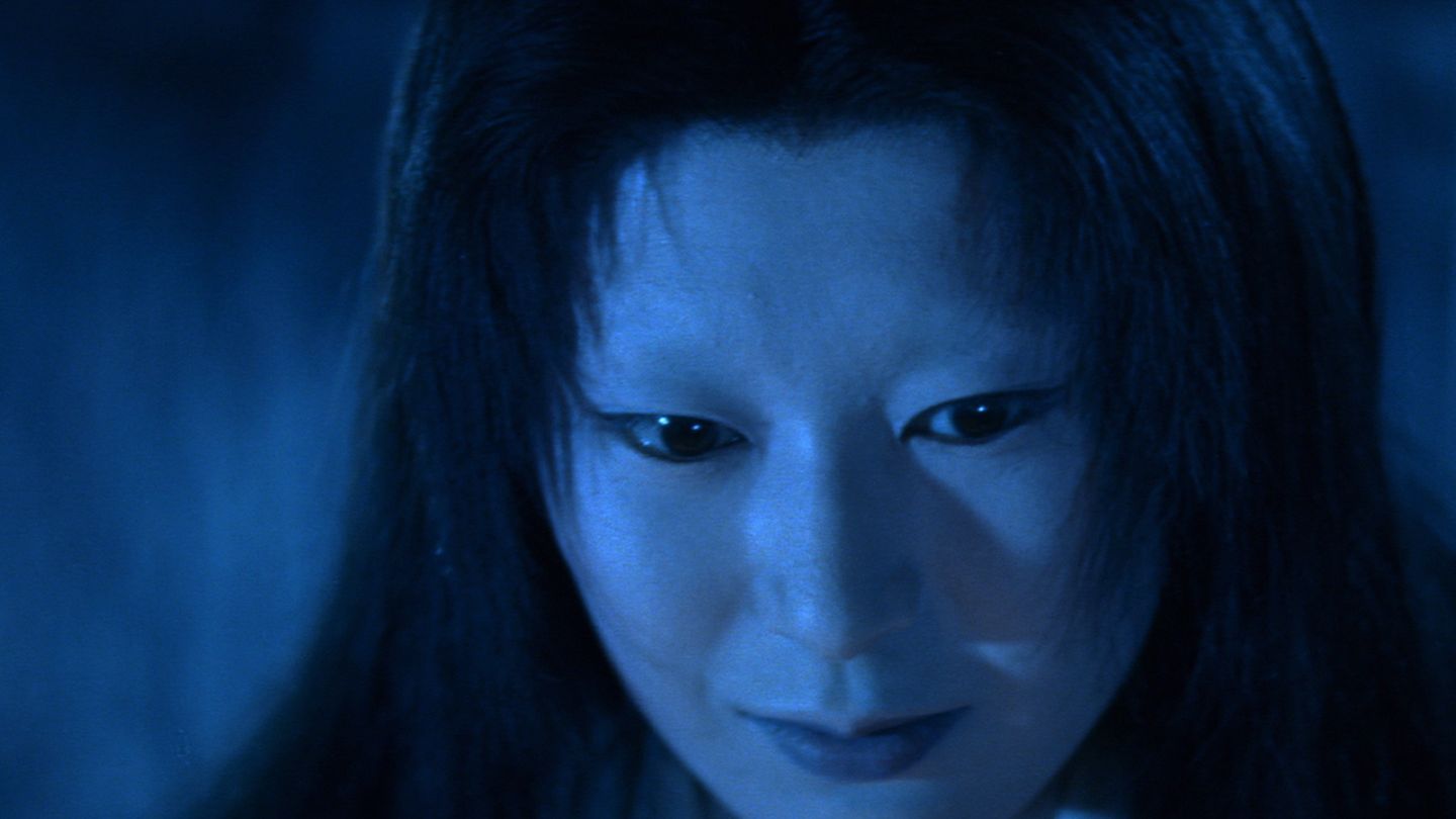 Blue-lit close-up of person's face