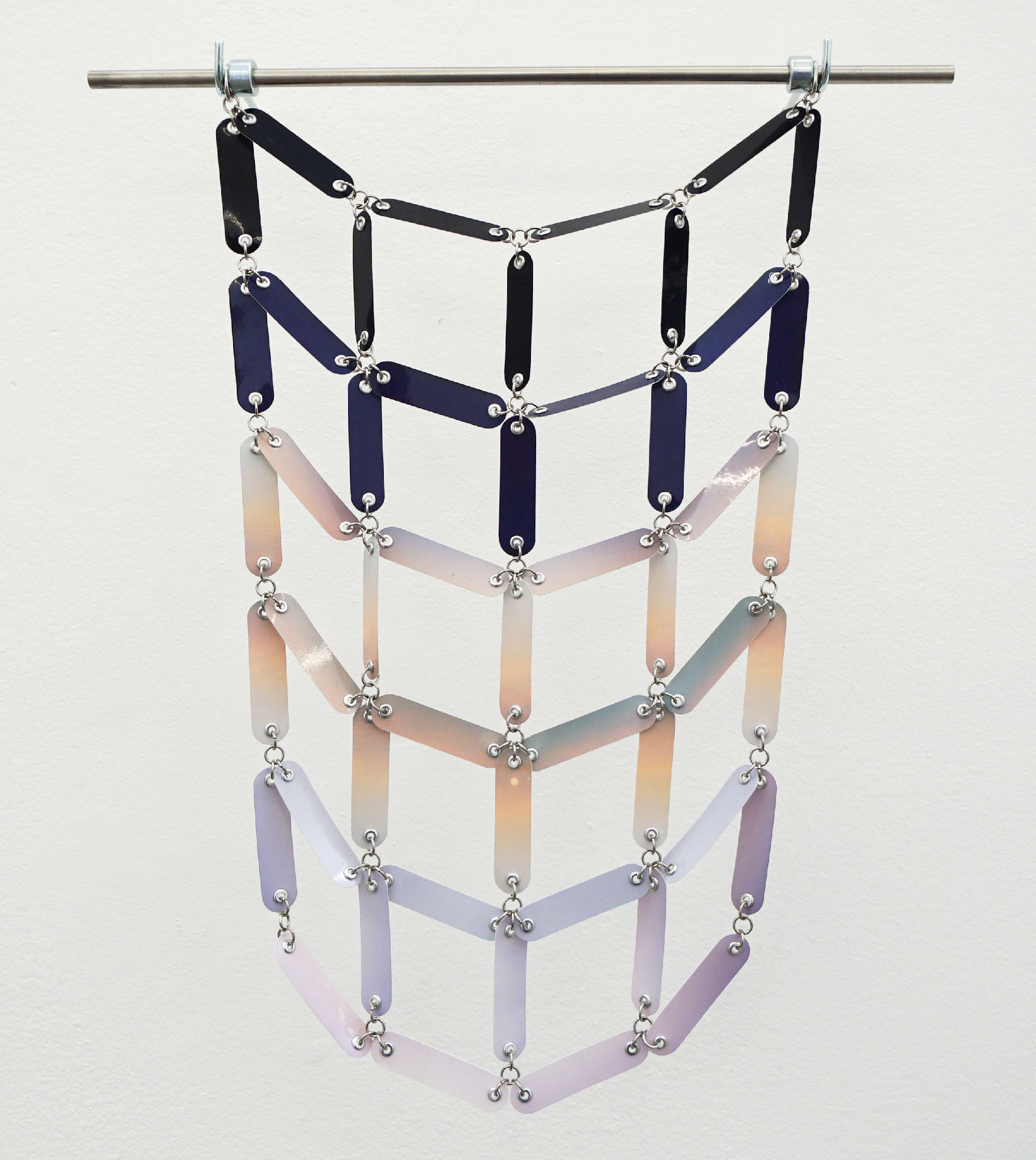 hanging wall sculpture with connected segments of grid hanging in curved drape