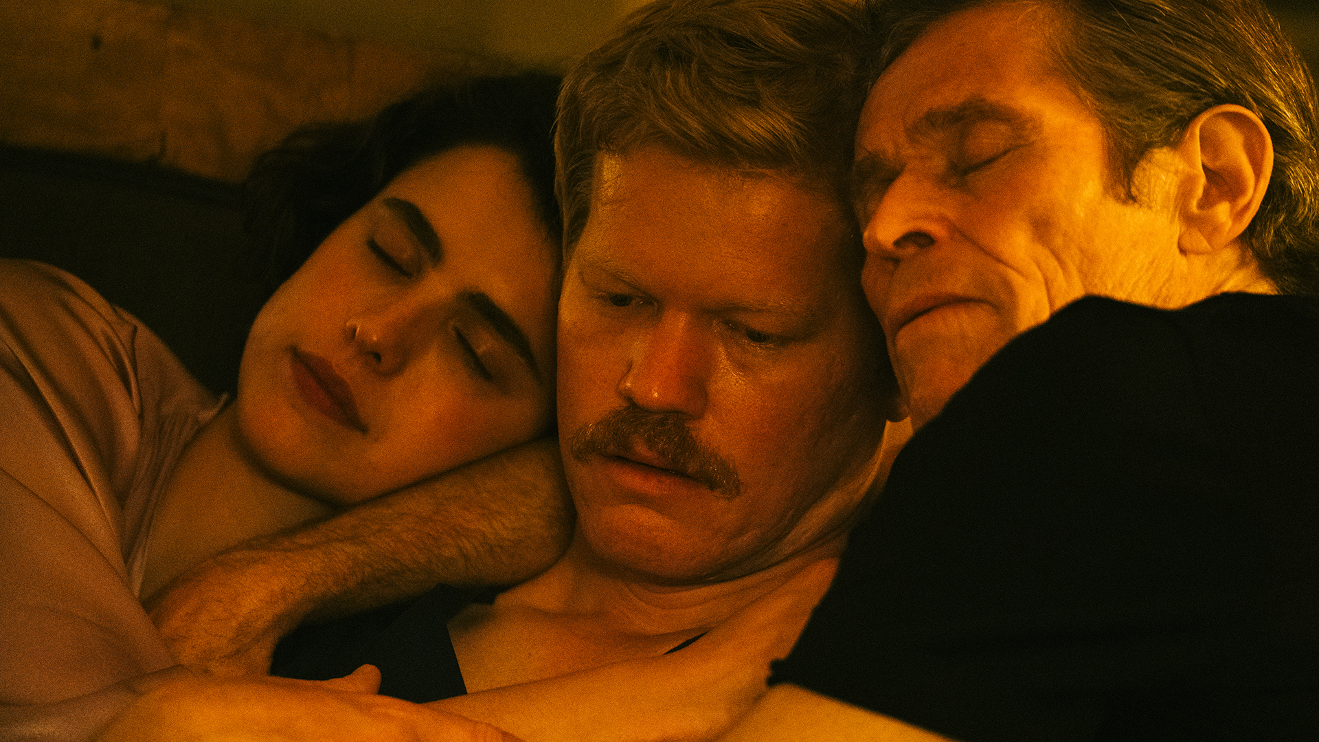 Three people with heads close in tightly cropped image