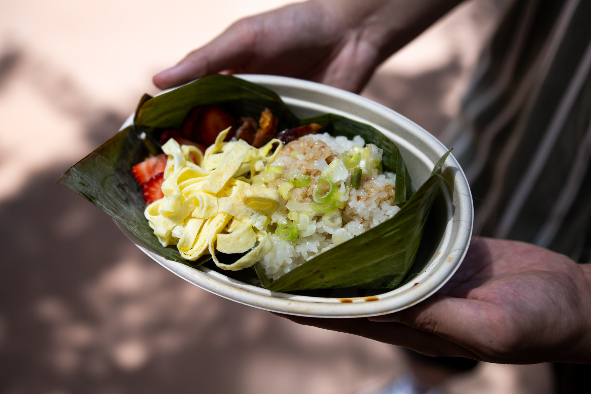 A bowl of Vietnamese sticky rice wrapped in a banana leaf.
