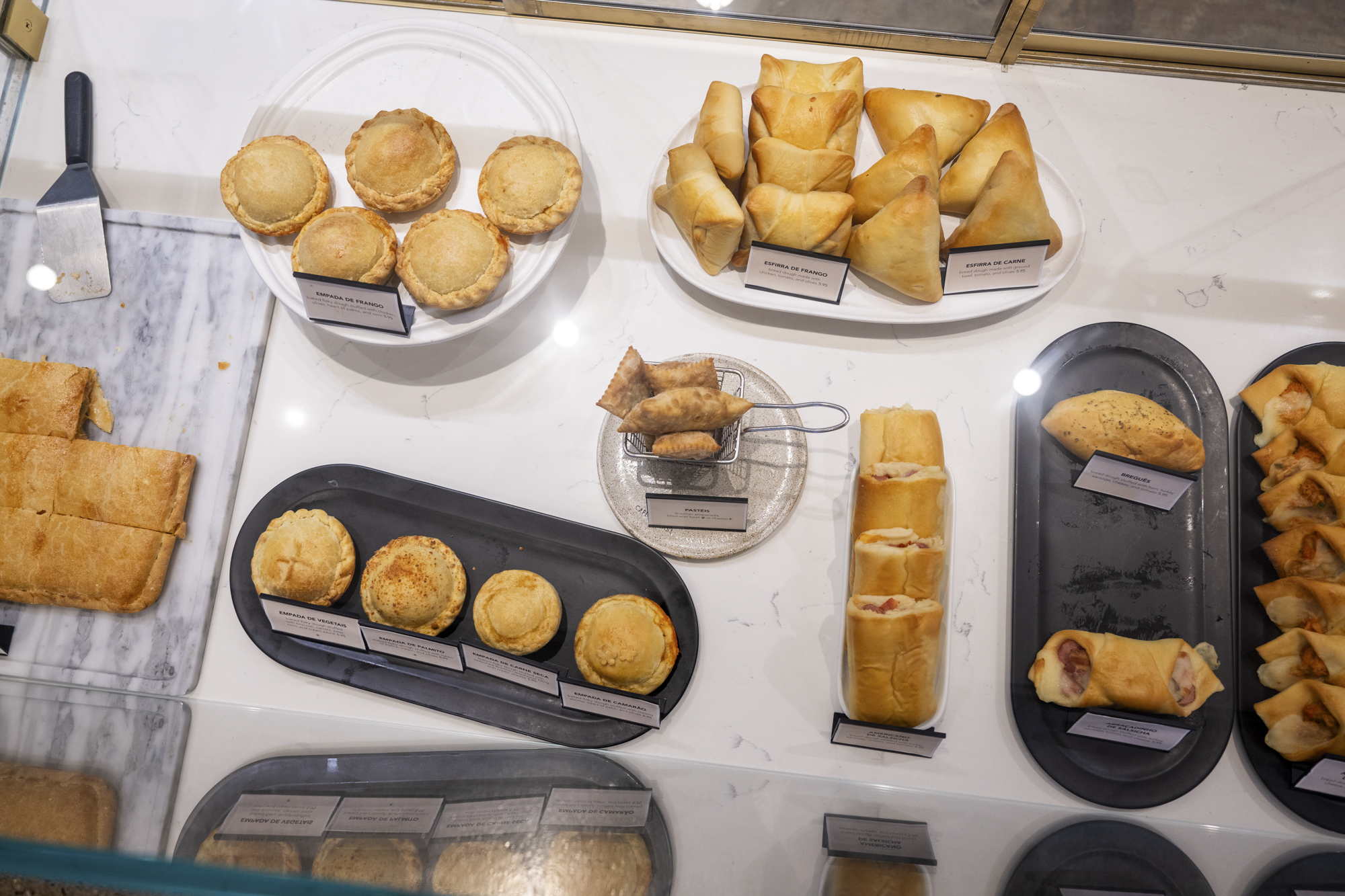 A spread of pastries inside a display case.
