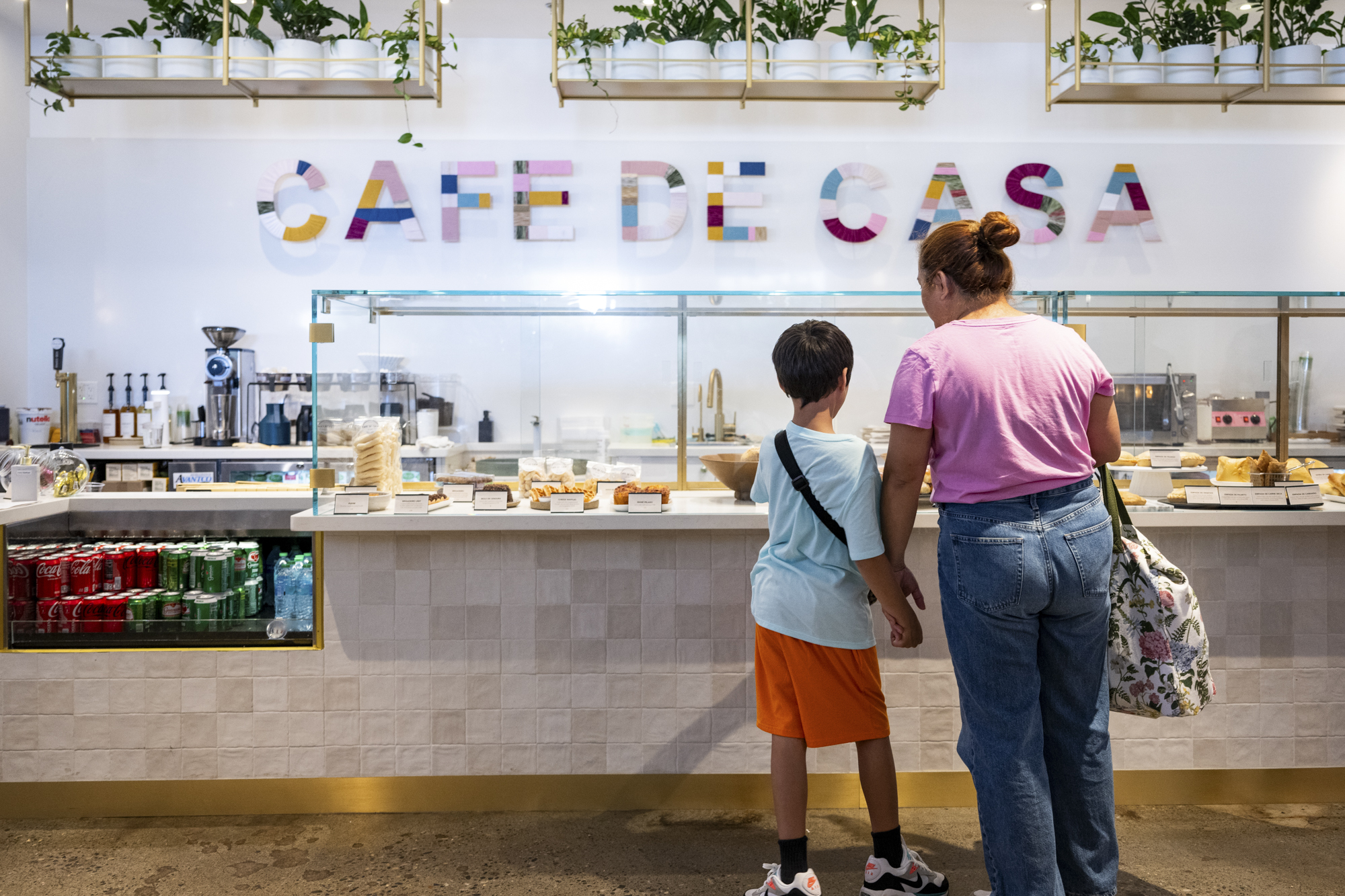 A woman and young boy peruse the pastry case at Cafe de Casa.