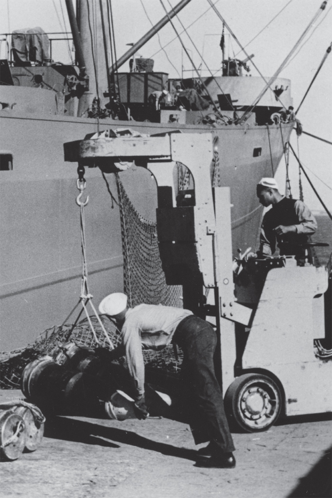 Navy servicemen working on the pier during WWII.