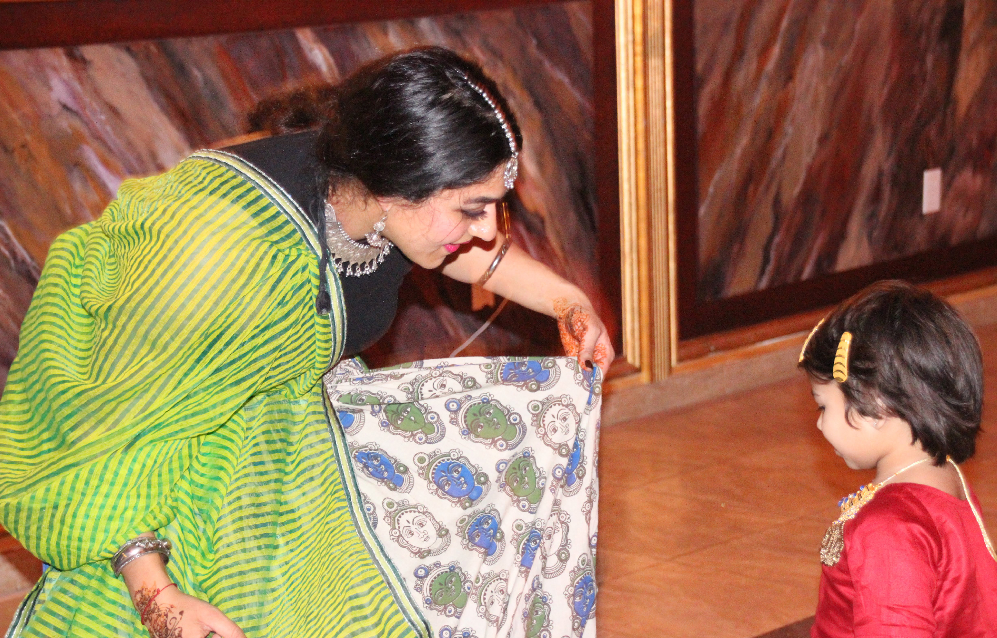 a woman performs a cultural dance with a child