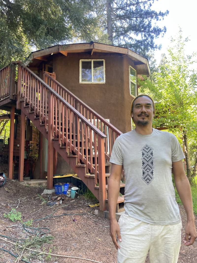 Ras K'dee stands in front of the NEST, a solar powered hub for Native artists in Forestville, CA. 