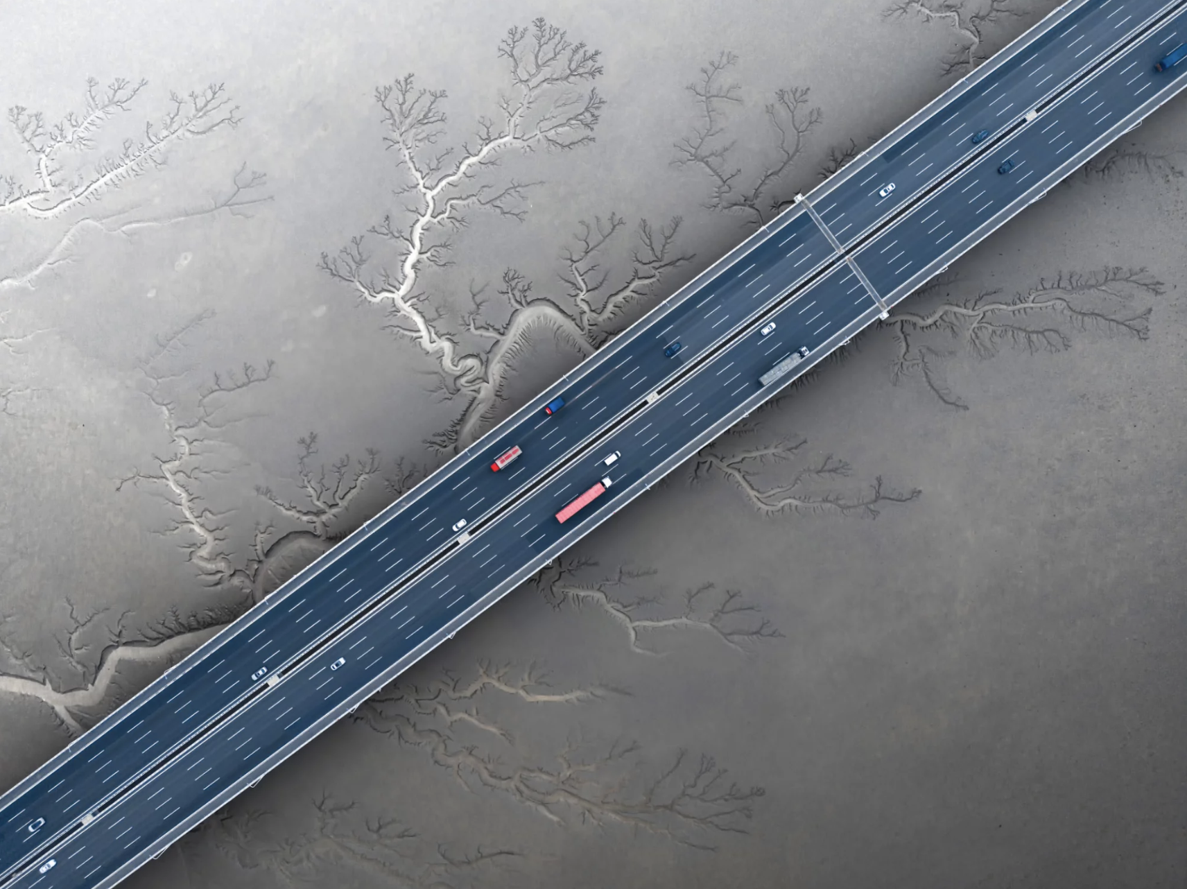 An aerial image of a highway cutting diagonally across a frozen body of water.