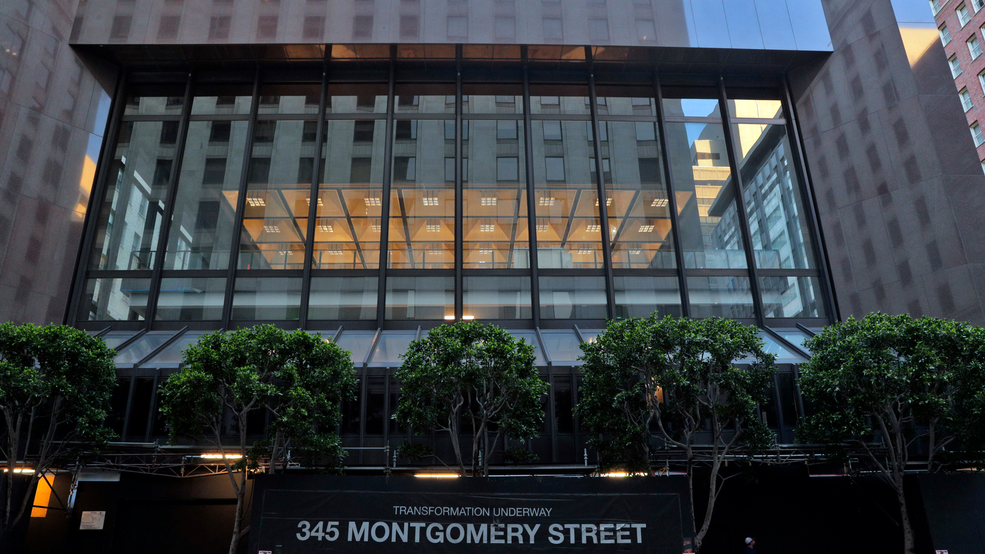 Modernist building with brown stone and large glass facade