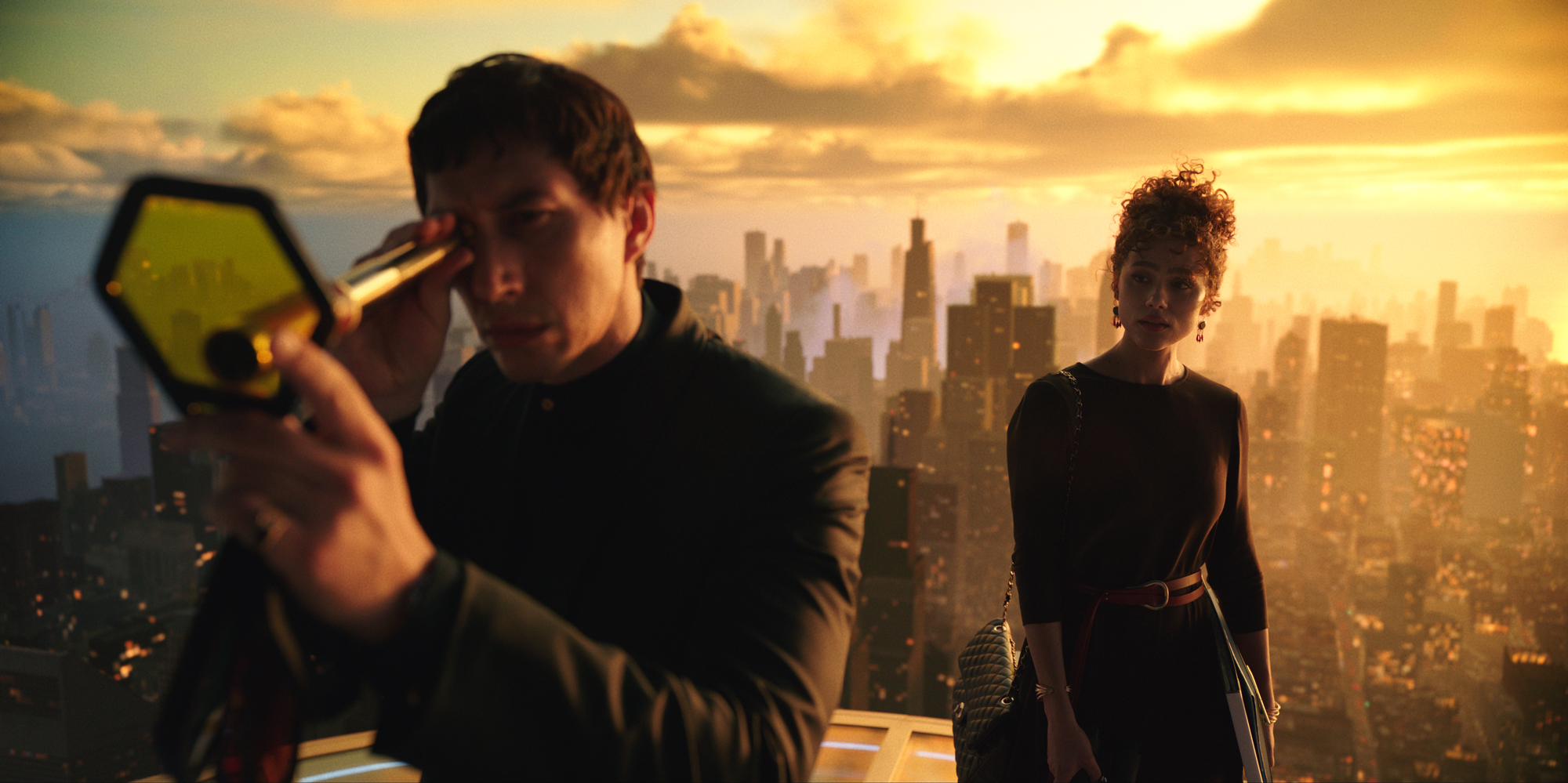 A man peers through a looking glass, a woman stands behind him, city in background