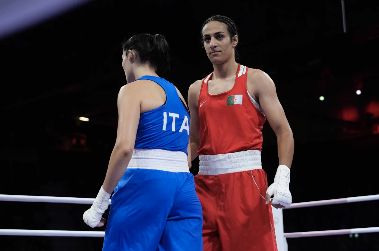 Two women in boxing kits inside the ring.