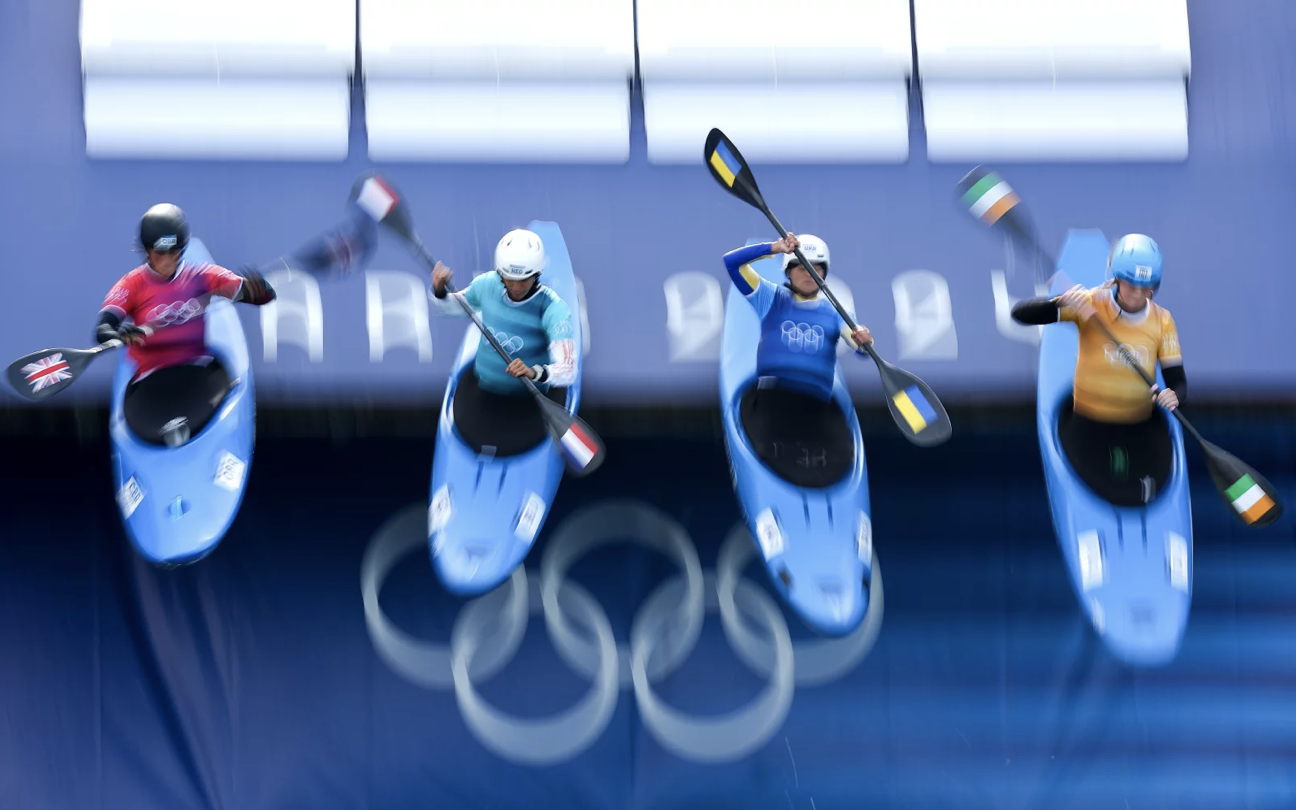 Four canoes with people in them being dropped from a great height.