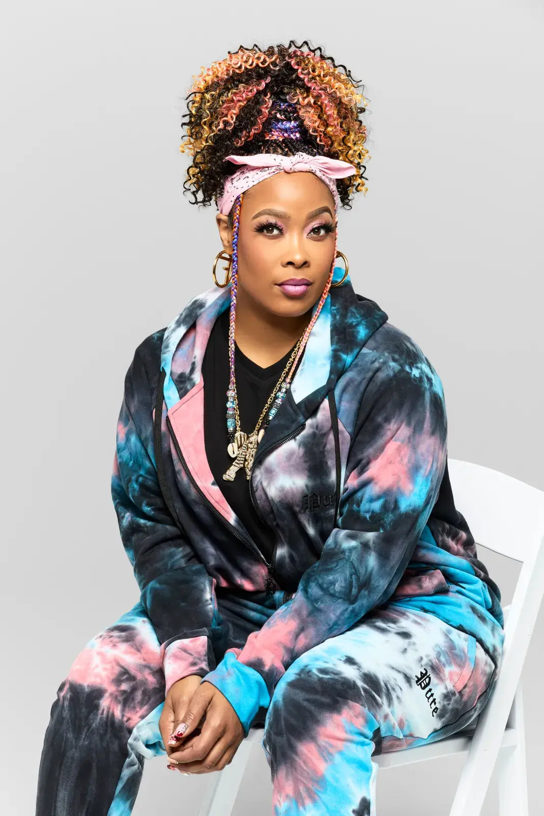 Da Brat poses for a portrait in a tie-dye sweat suit.