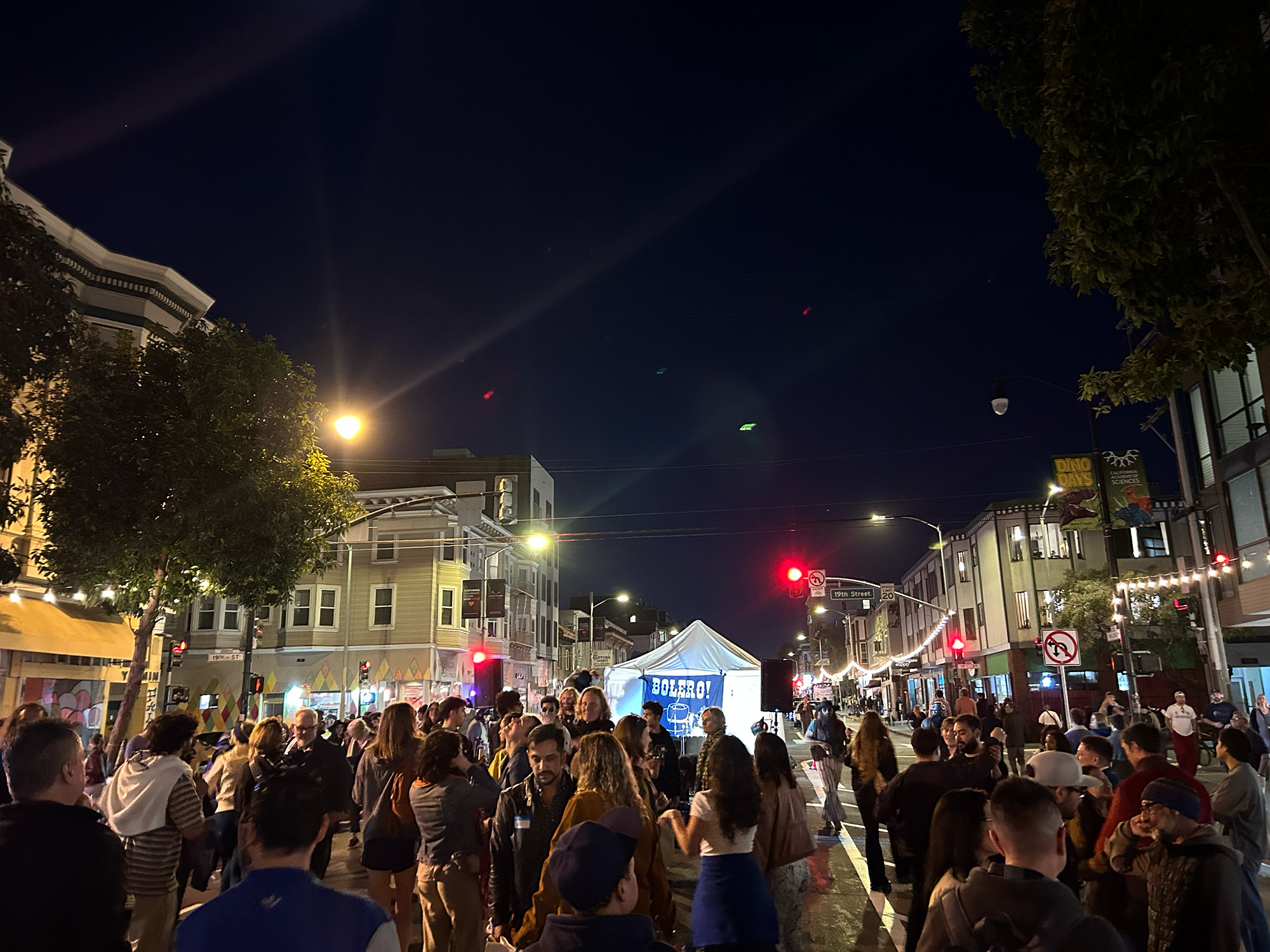 Crowded street party at night.