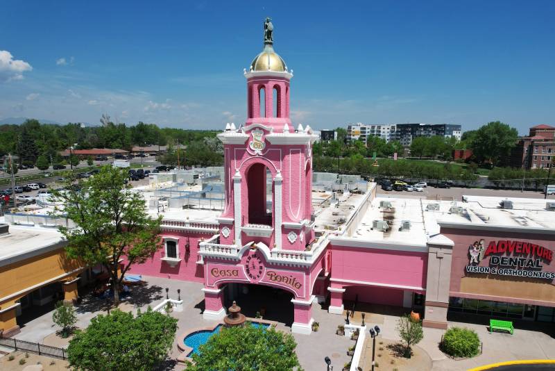 A grand pink building with a bell tower.