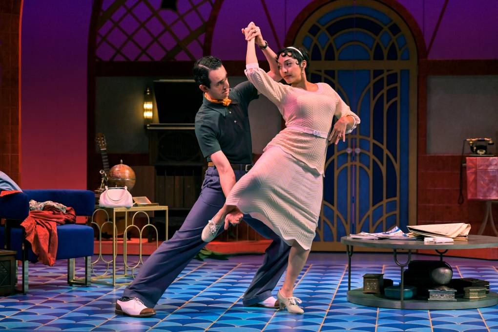 a man and a woman caught mid-dance atop a blue rug