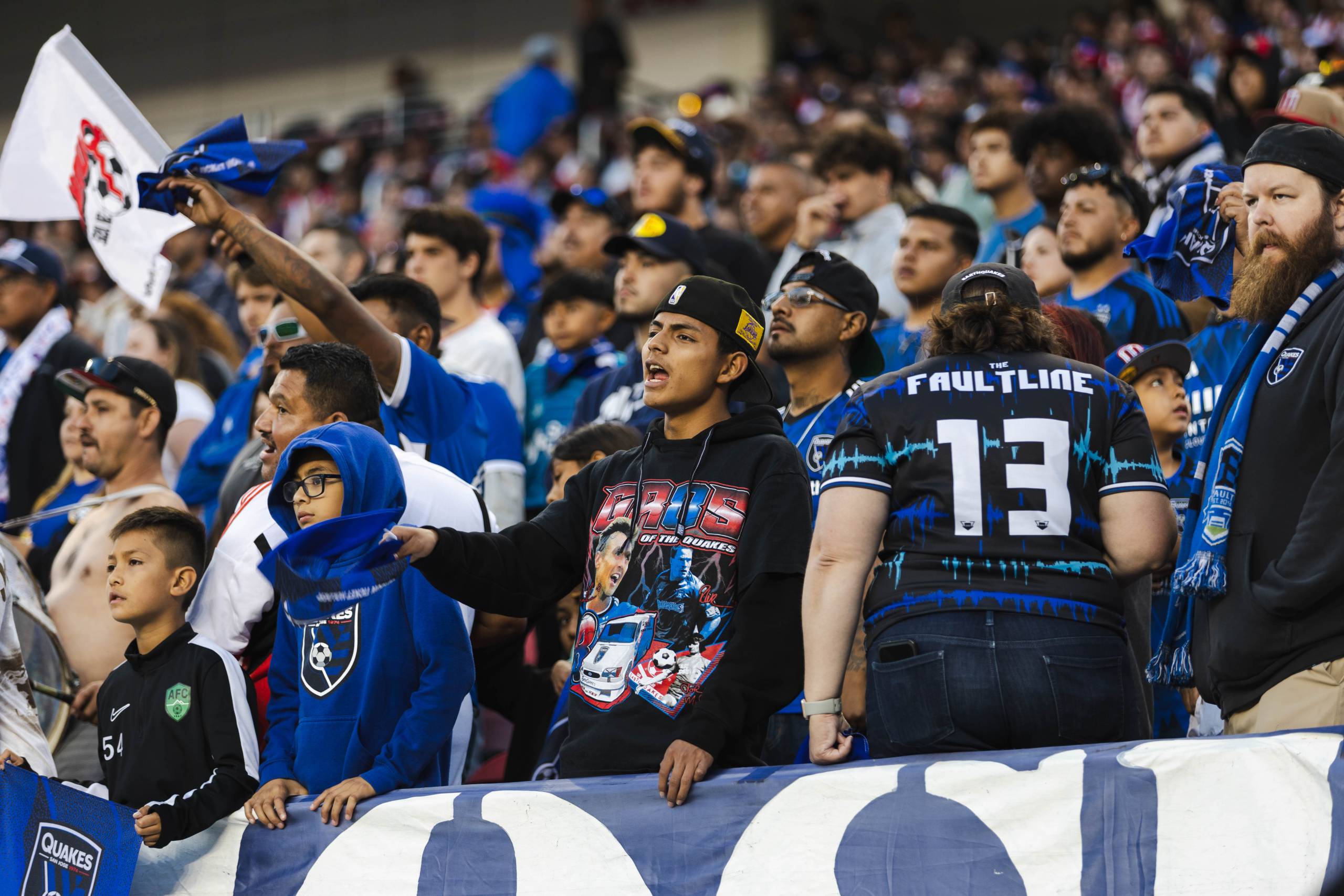 fans cheering for the San Jose Earthquakes during a professional soccer game