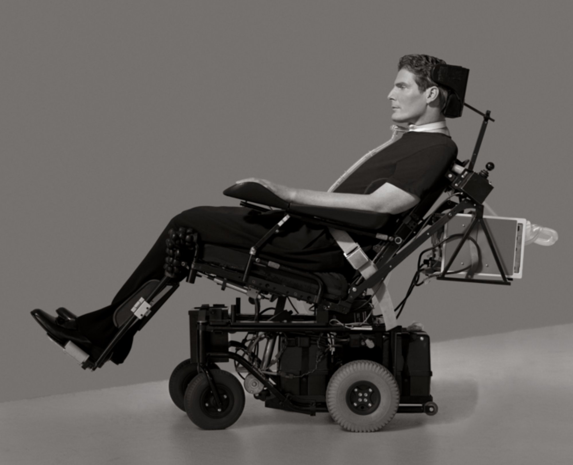 A man in a wheelchair, viewed in side profile.