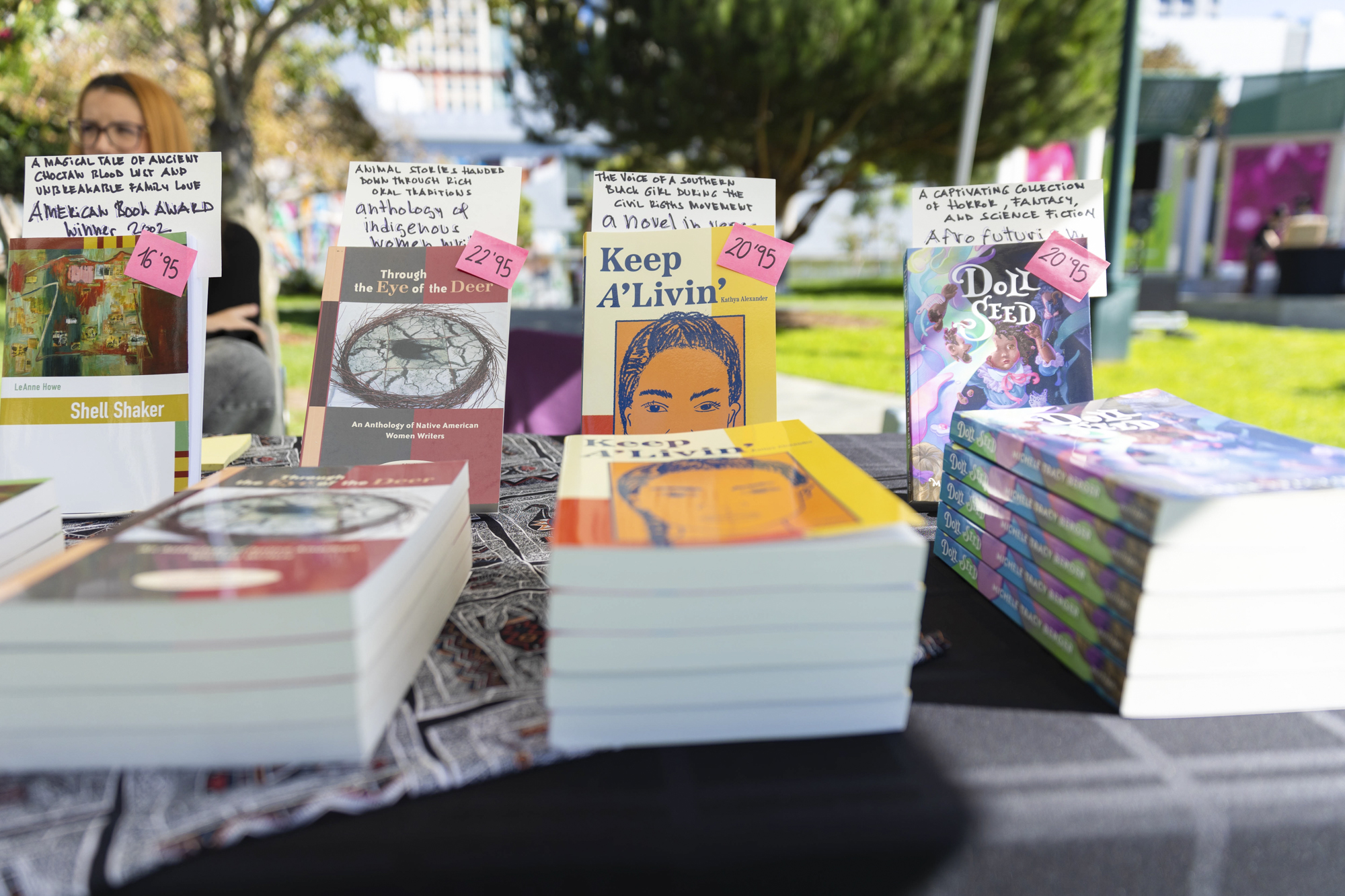 stacks of books on table at outdoor event