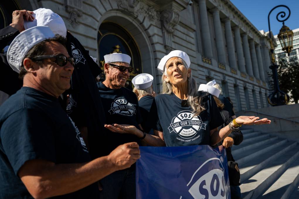 group in matching shirts and sailor hats in front of SF City Hall