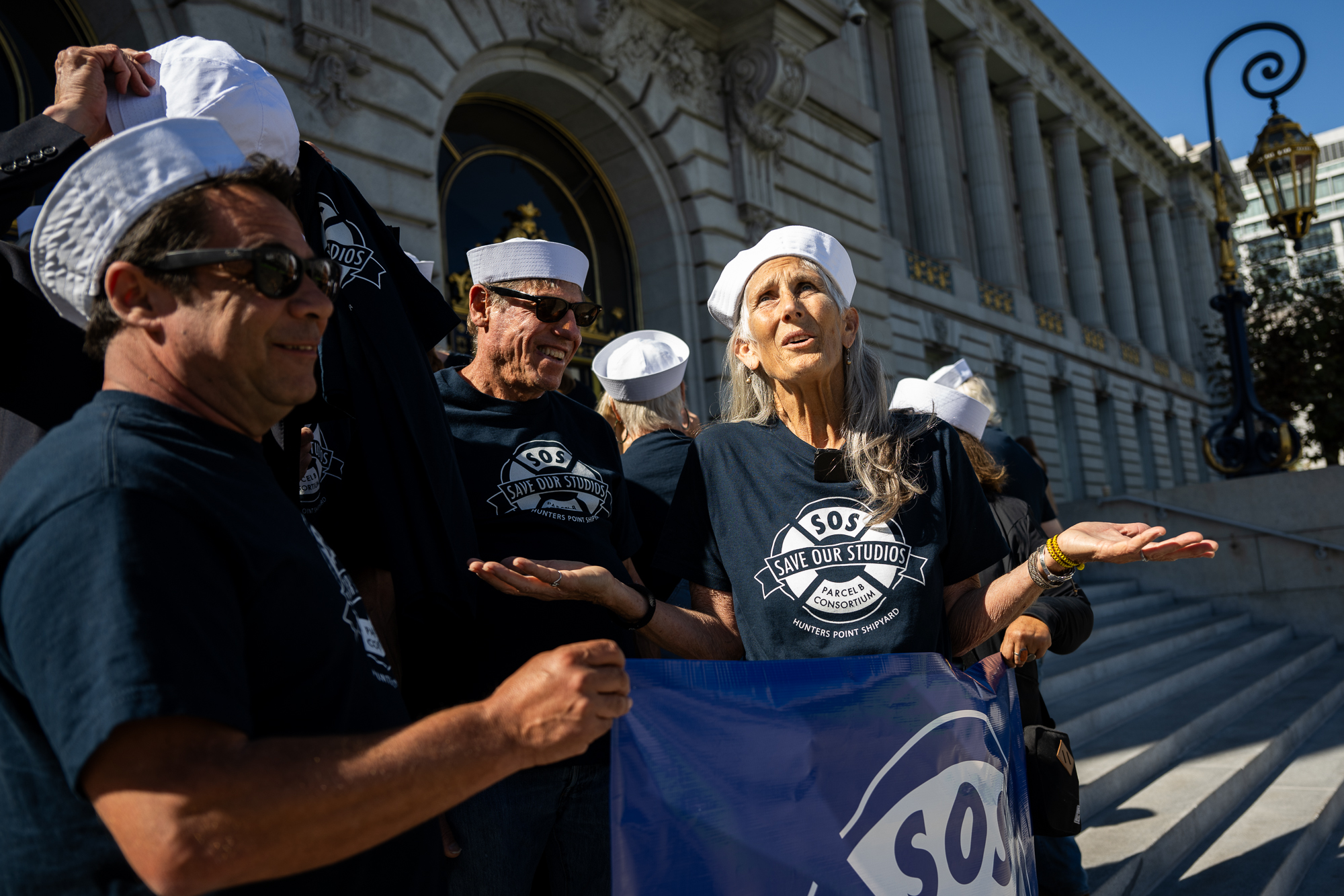 group in matching shirts and sailor hats in front of SF City Hall