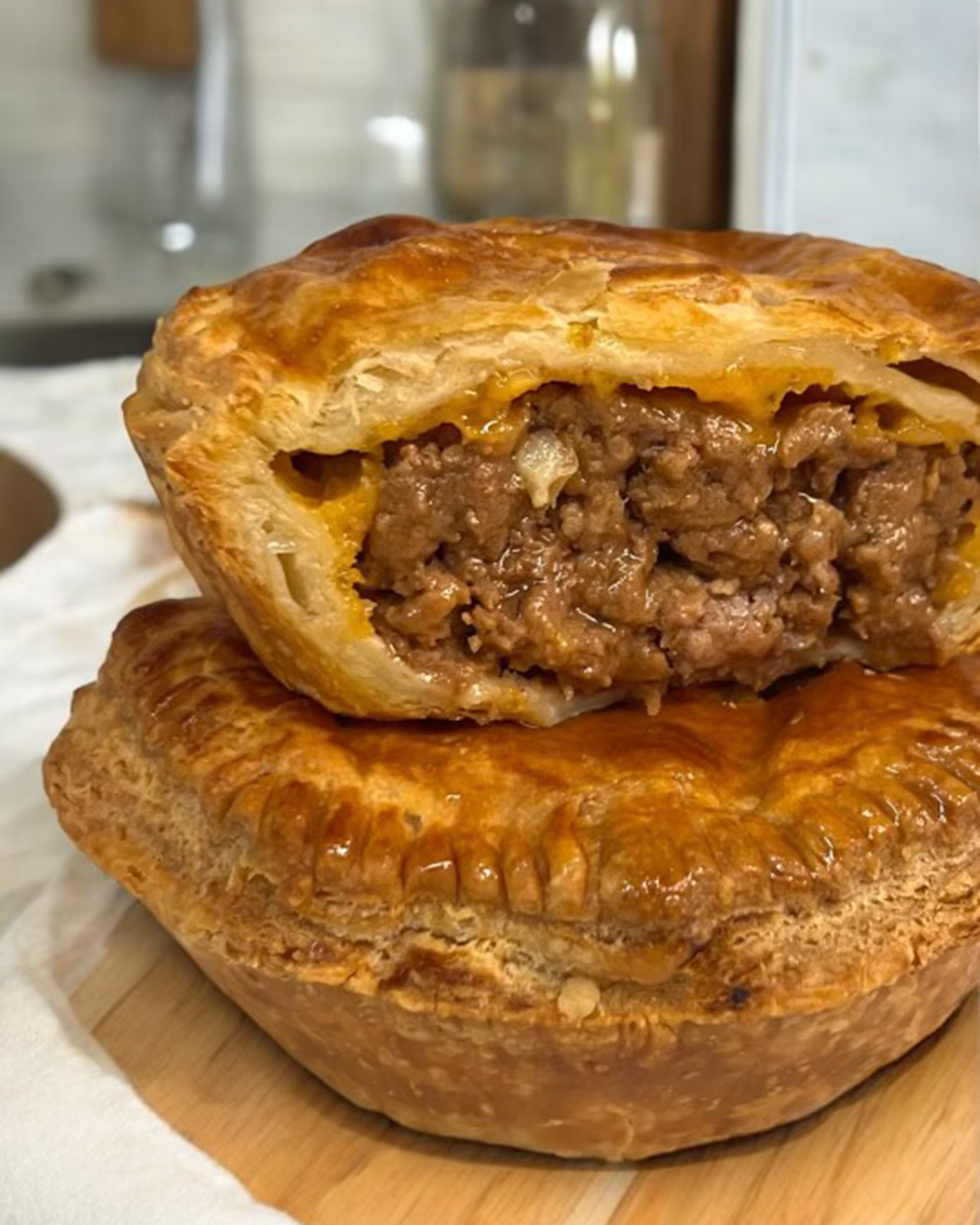 Fijian meat pie cut open so that the meaty cross section is visible.