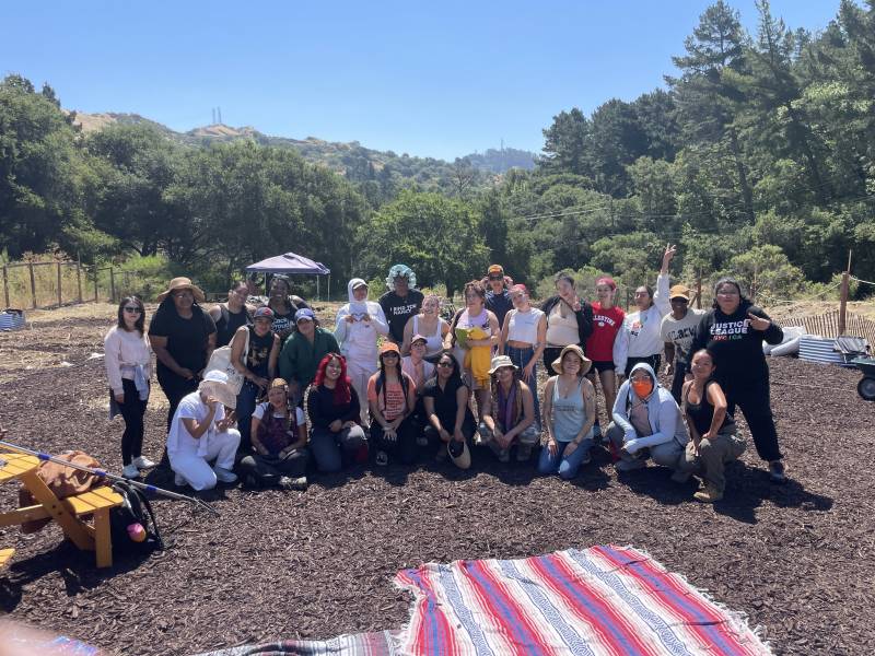 A group of volunteers pose at a farm.