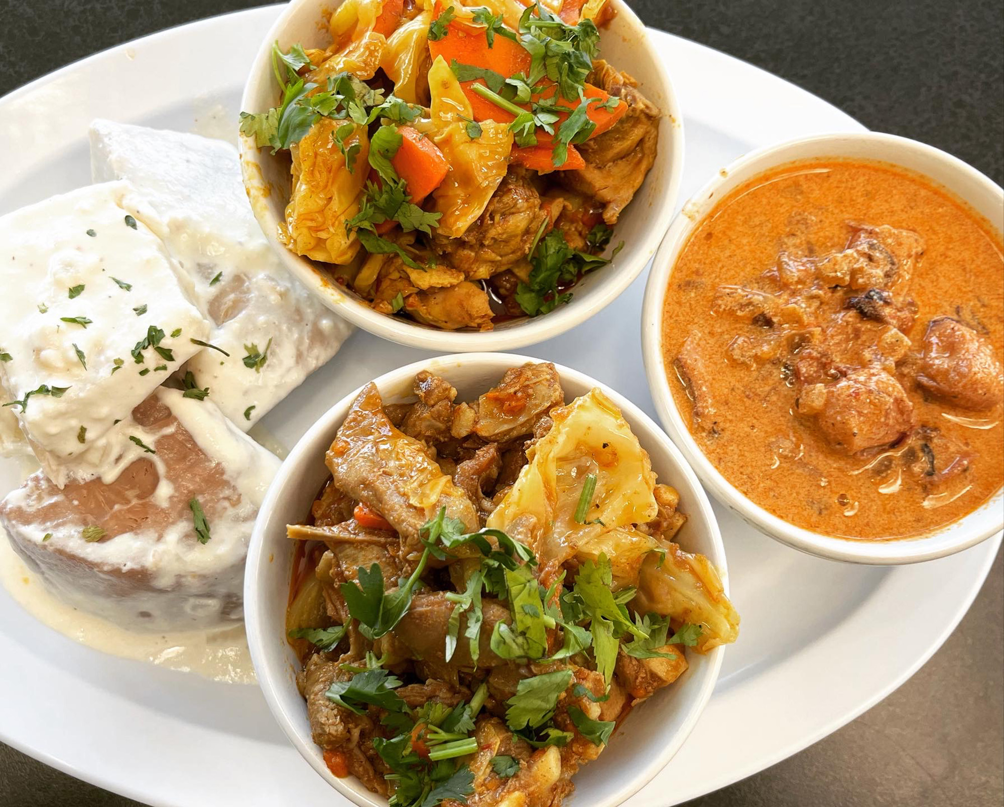 A platter of assorted Tongan stews and other Polynesian dishes.