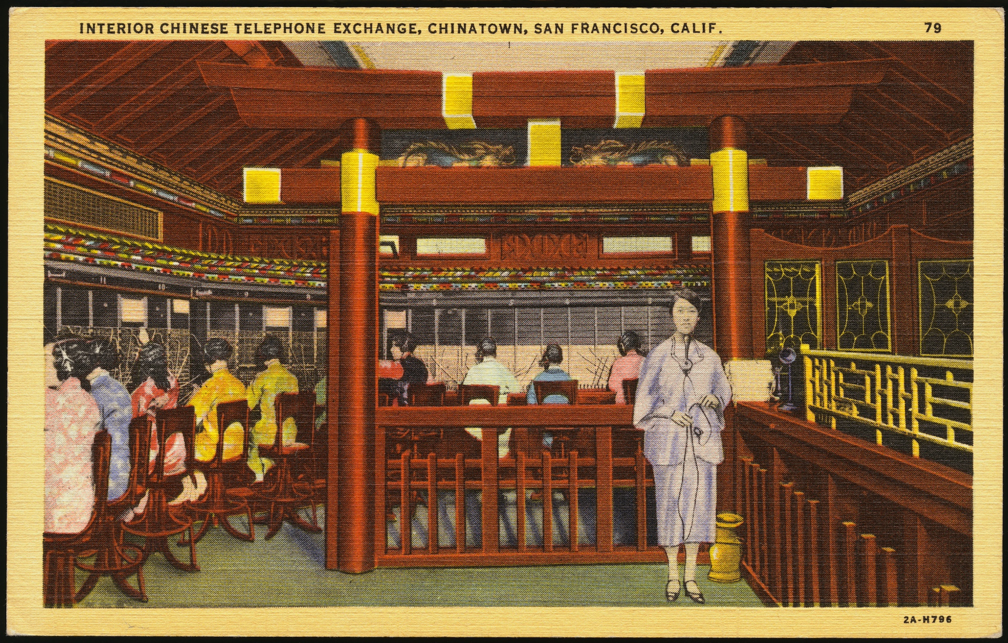 A postcard depicting women lined up around the perimeter of a wooden, attractively decorated room. They are all working at a switchboard while one standing woman watches on.