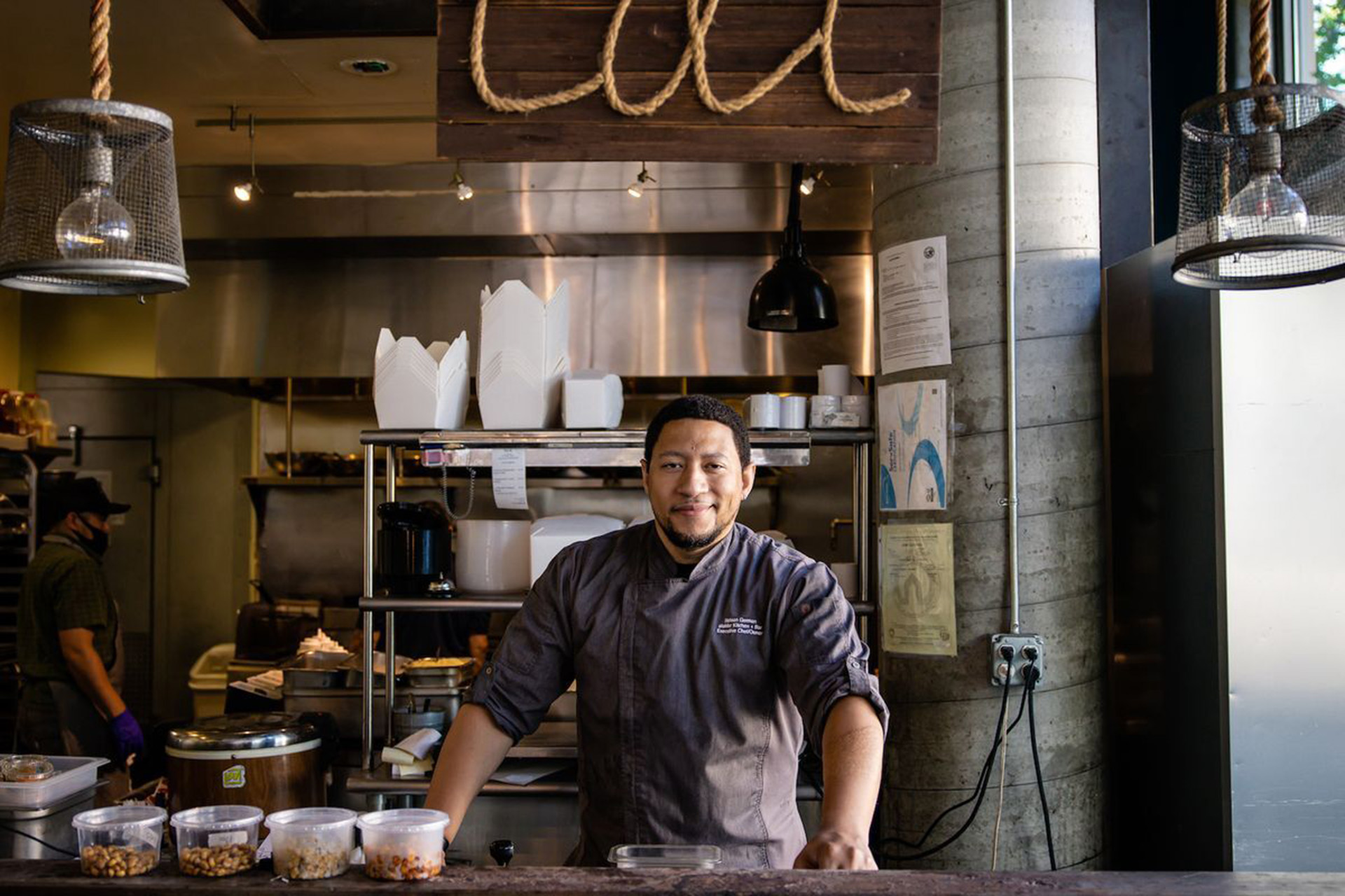 A chef poses inside his restaurant.