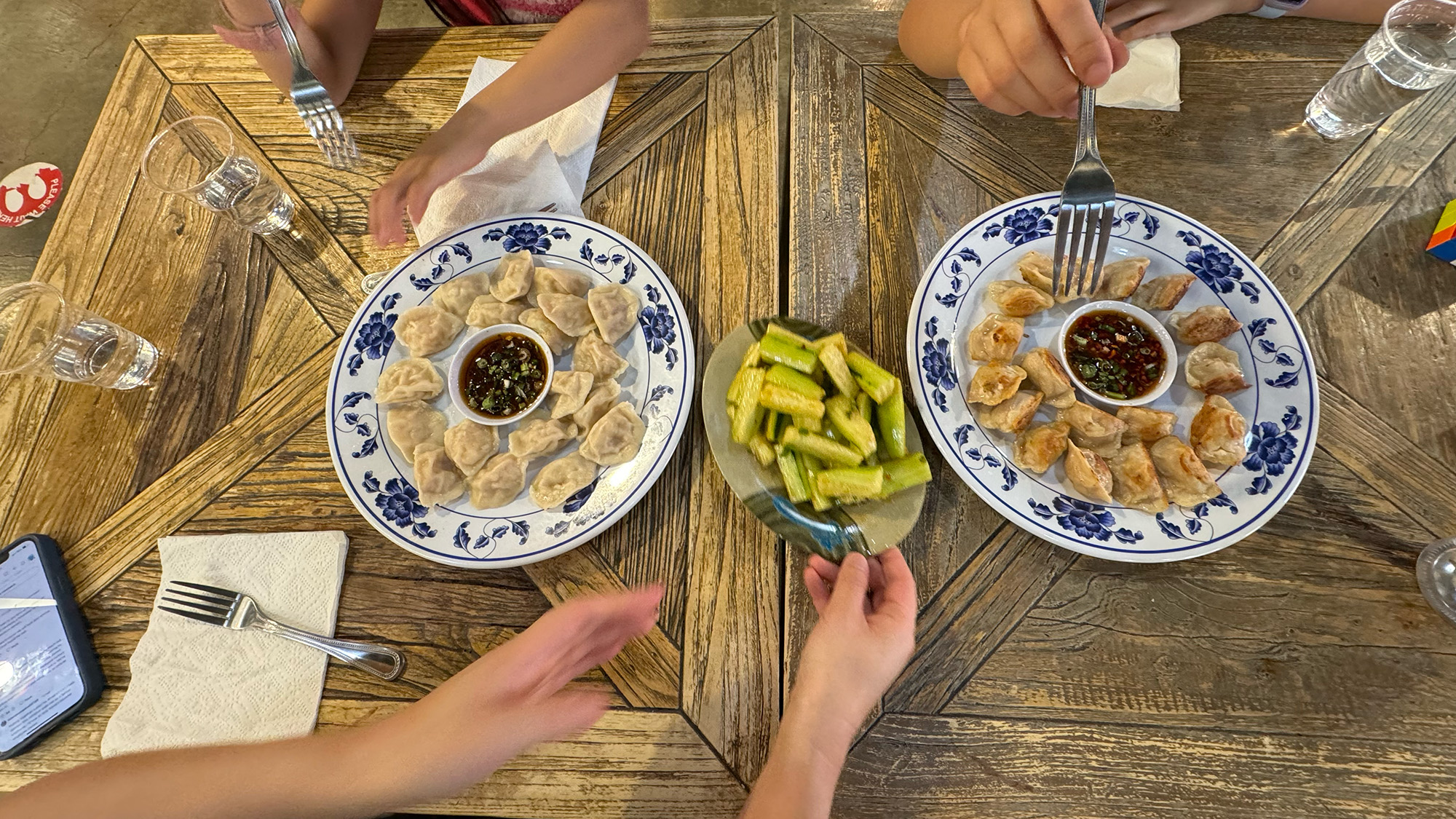 A spread of dumplings on a wood table.