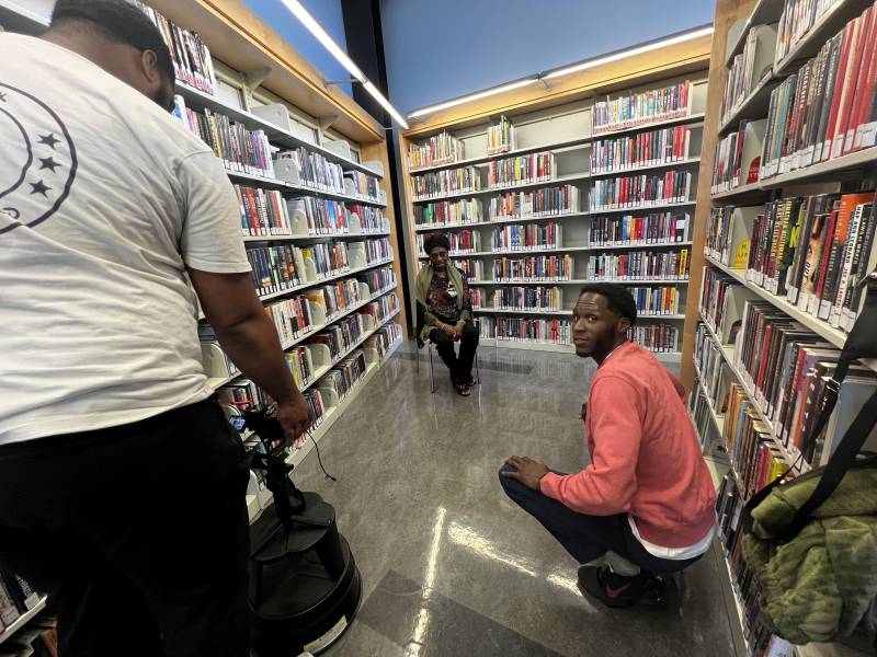 President and co-founder of The Black Neighborhood, Cory Elliott, interviewing Barbara Given-Cohen at the Bayview Linda Brooks-Burton Branch Library. 