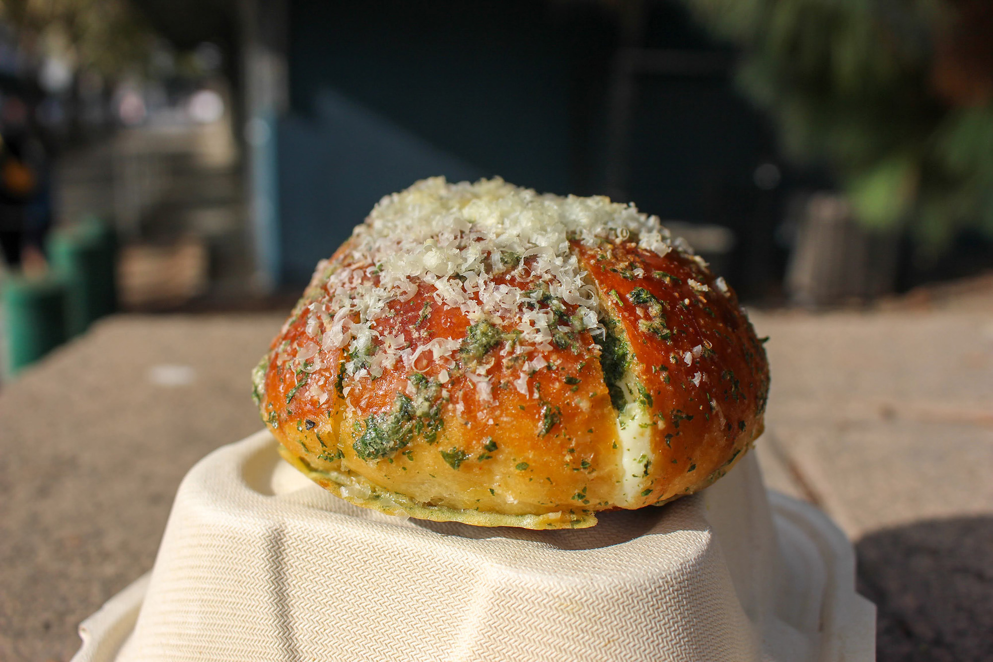 A savory bun dusted with Parmesan cheese.