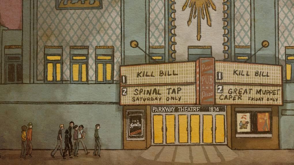 A baby blue movie theater with gold adornments pictured at night, with a marquee advertising 'kill bill' and 'the great muppet caper'