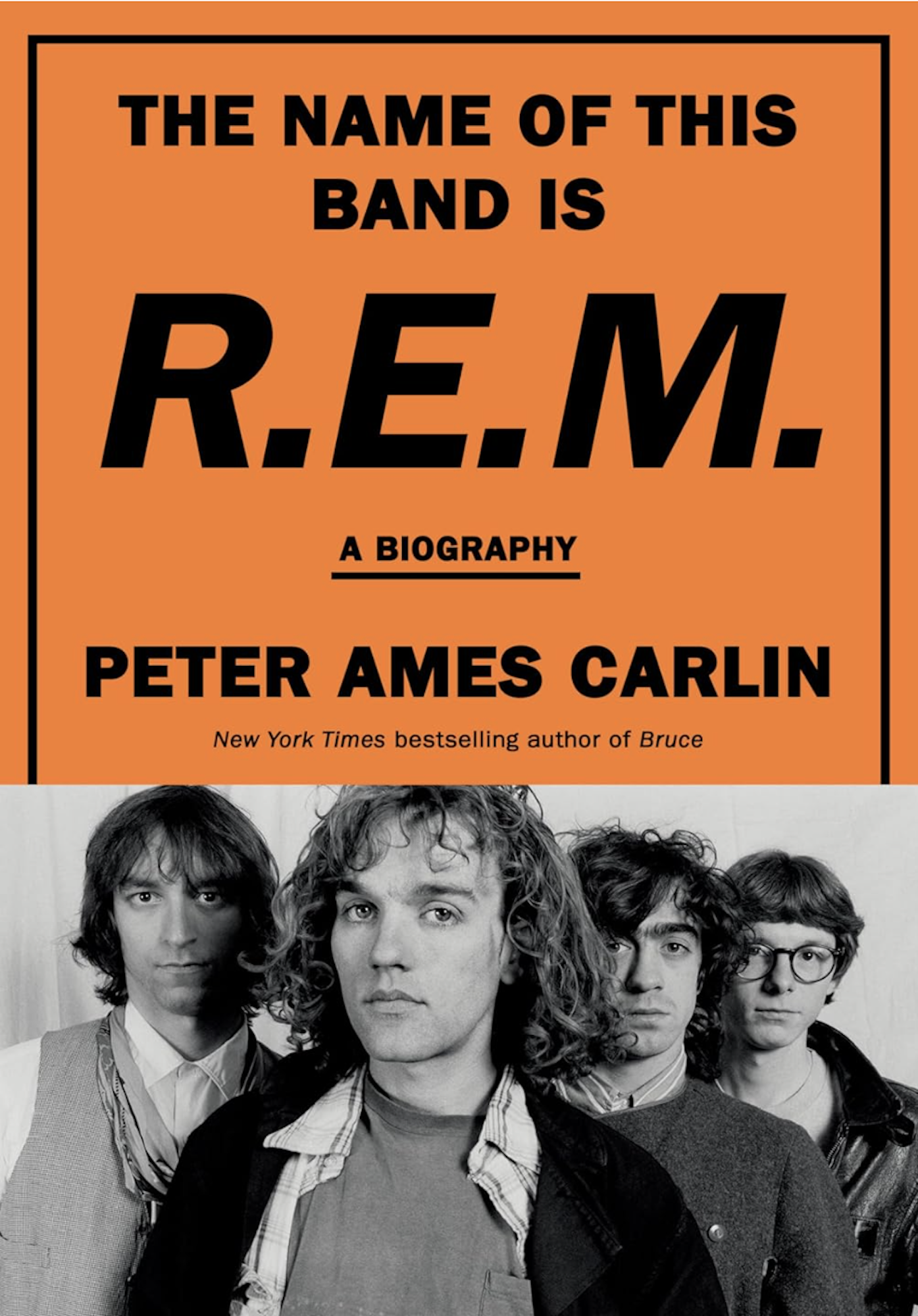 An orange book cover featuring a black and white image of a band.