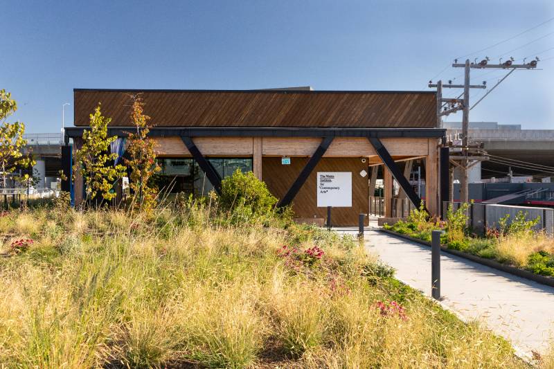 low-slung building with grasses in foreground