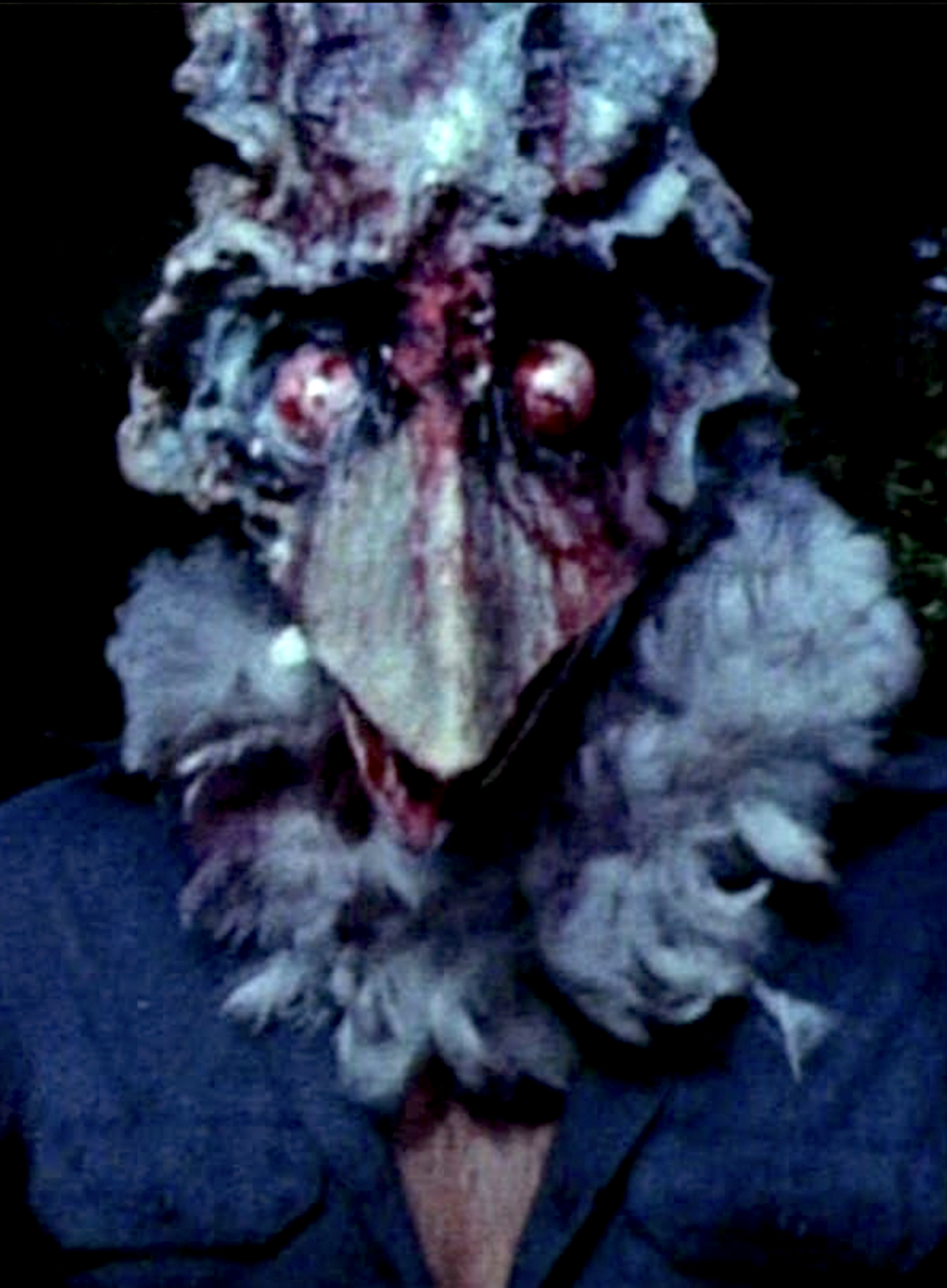 A man's body with the head of an evil-looking turkey.